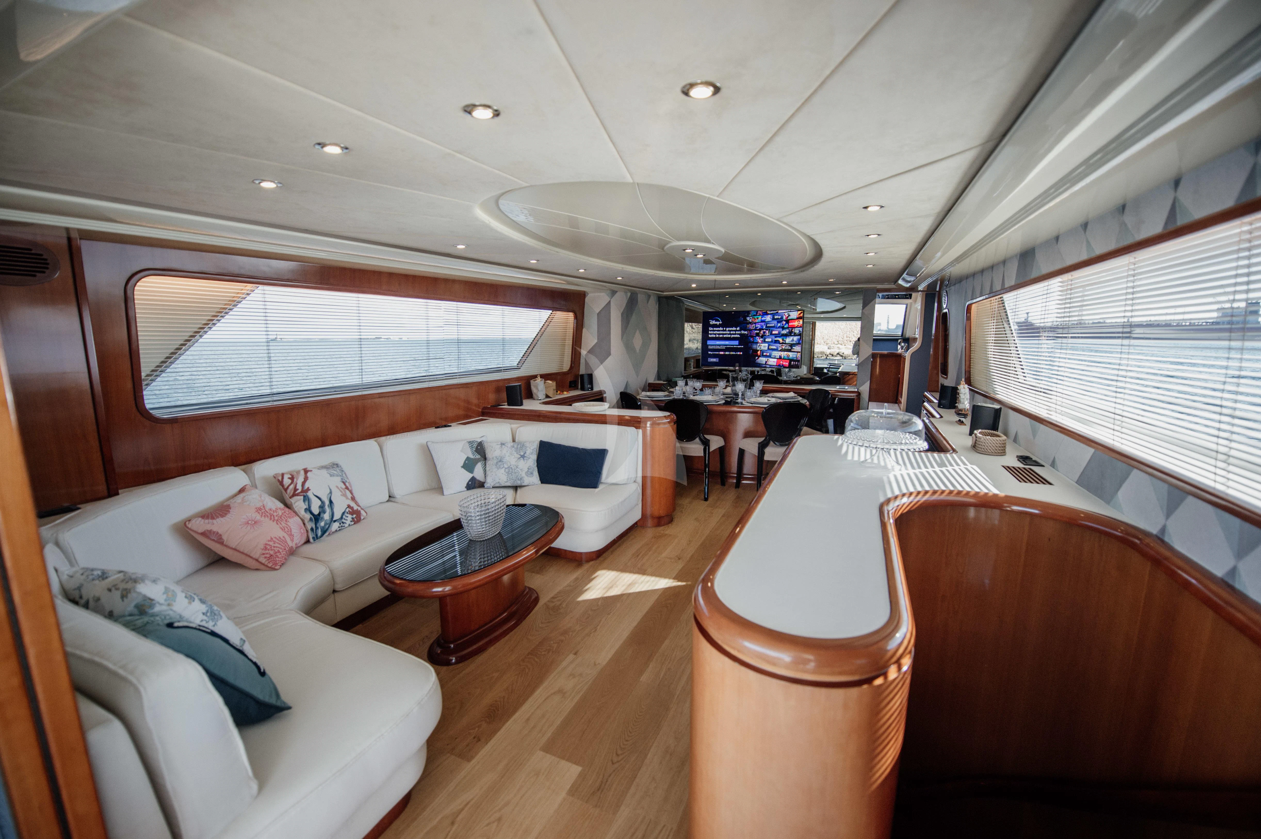 a room with a couch and a table and a window aboard BEYOND Yacht for Charter
