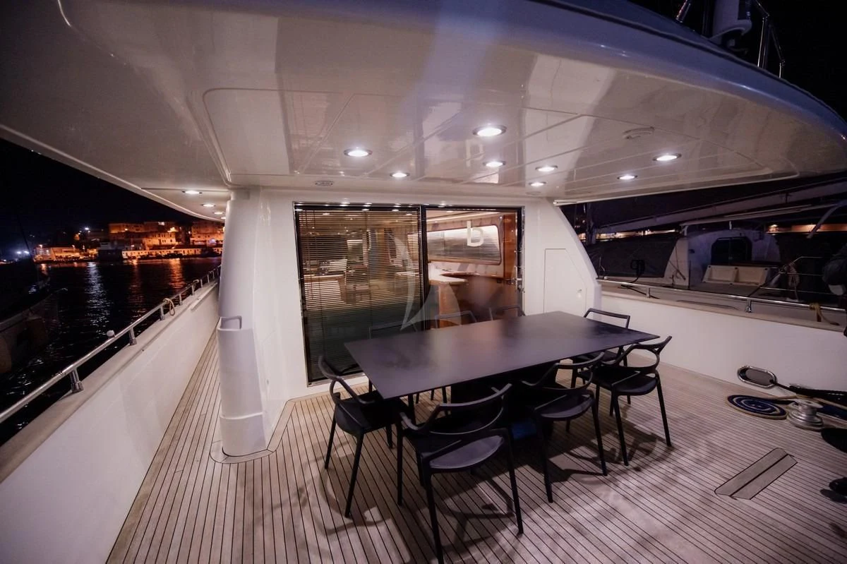 a table and chairs in a room aboard BEYOND Yacht for Charter