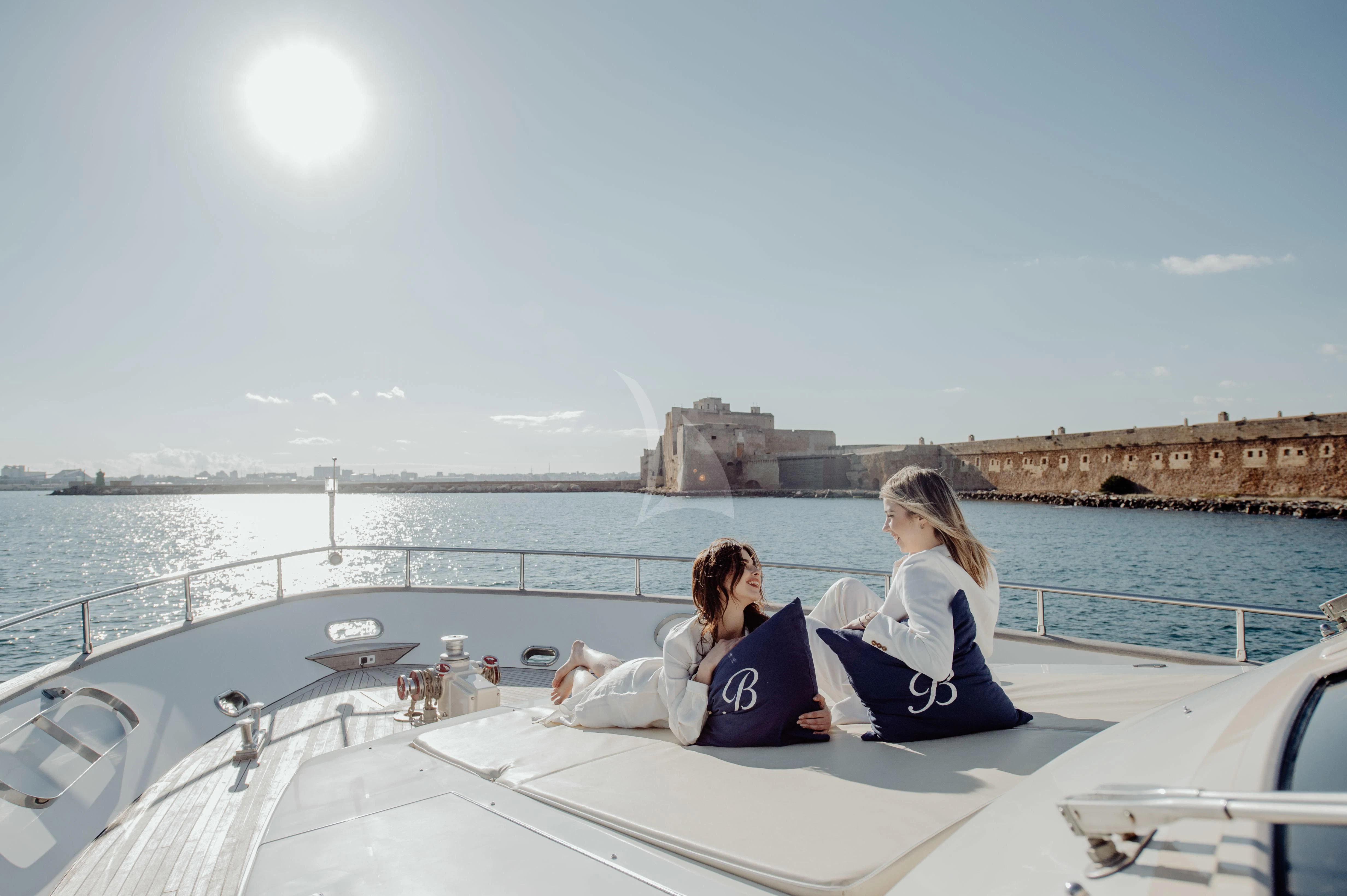 a couple of women sitting on a boat in the water aboard BEYOND Yacht for Charter