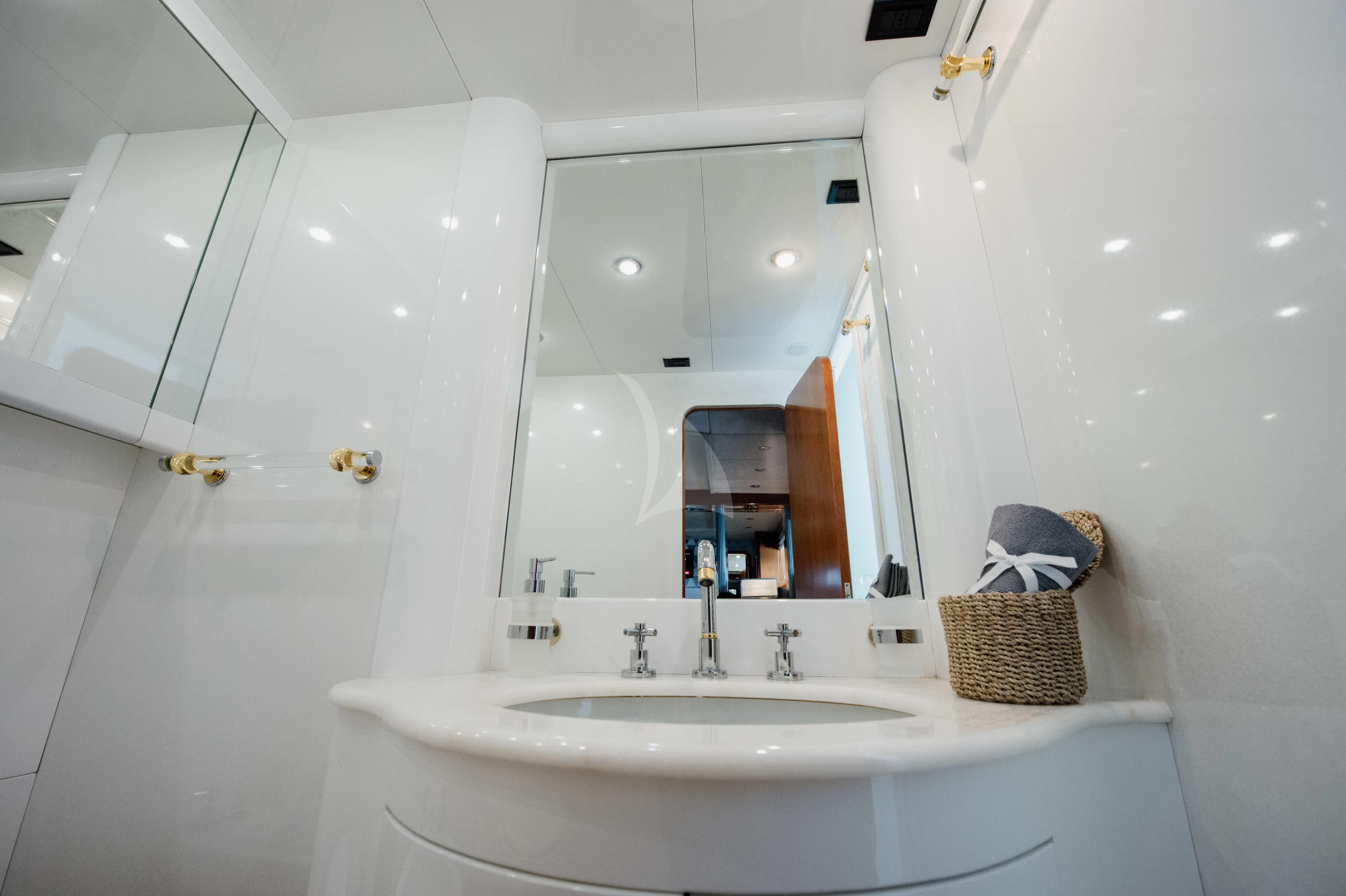 a bathroom with a sink and mirror aboard BEYOND Yacht for Charter