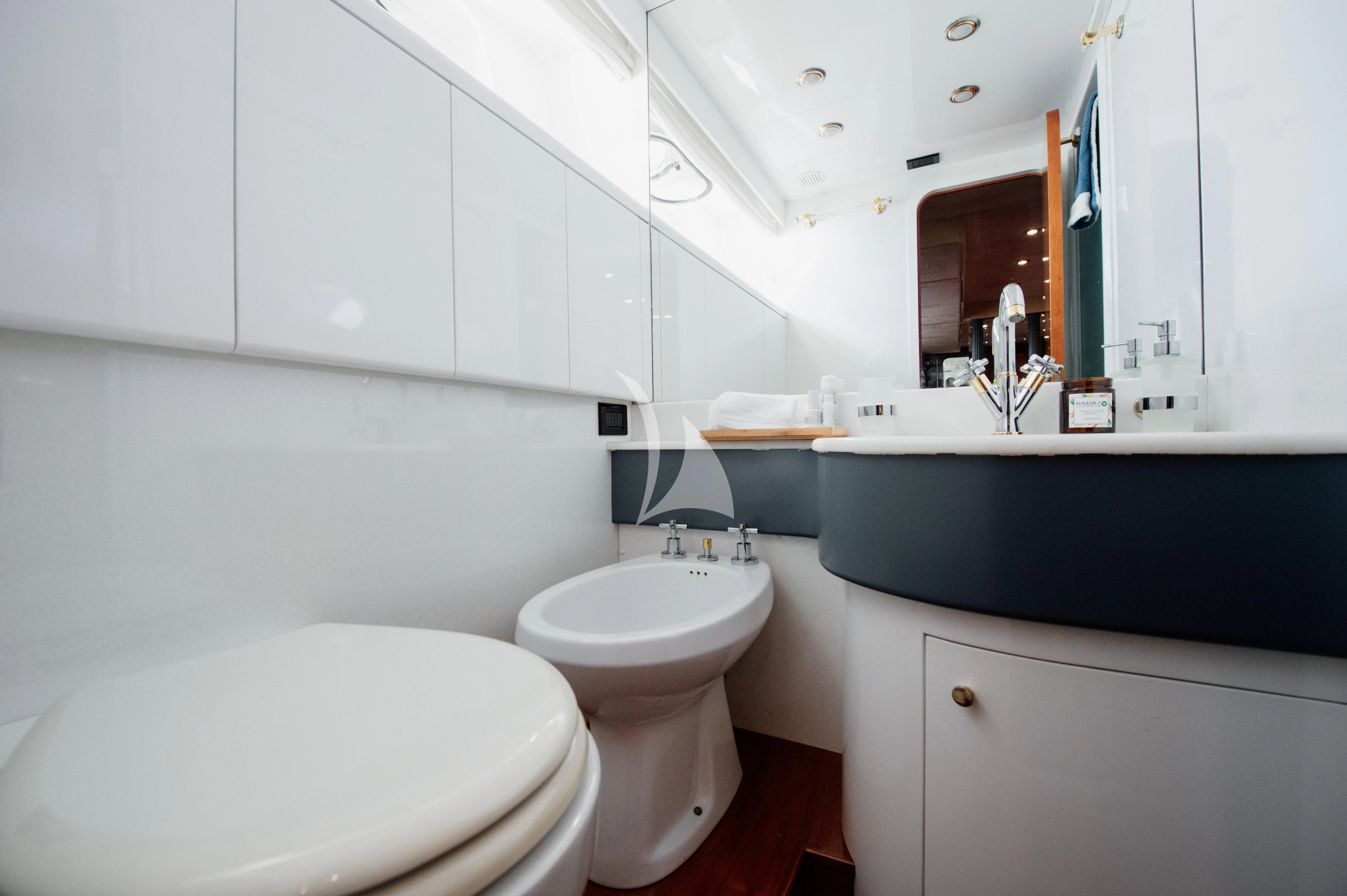 a bathroom with a tub sink and toilet aboard BEYOND Yacht for Charter