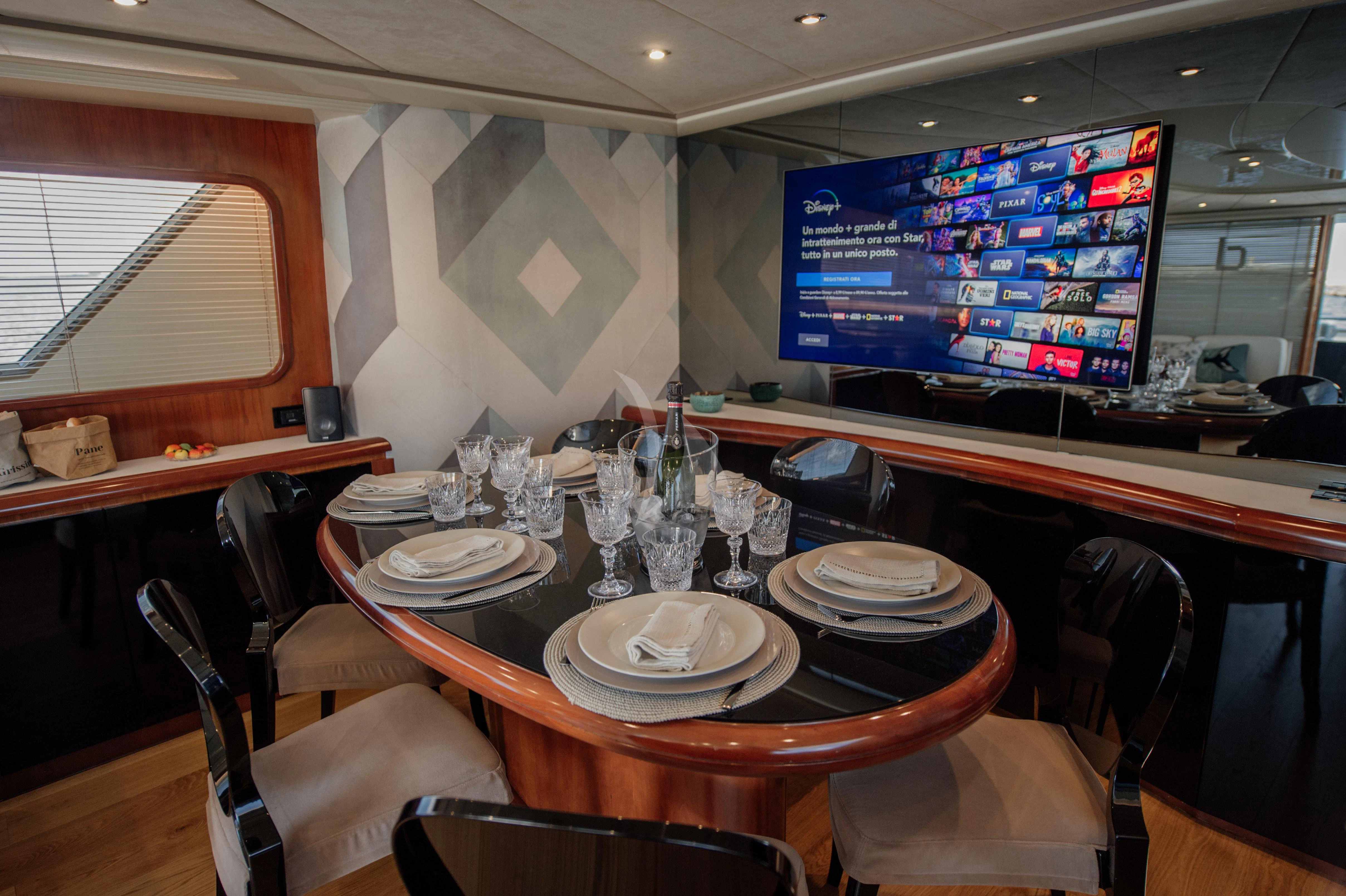 a table with plates and cups on it aboard BEYOND Yacht for Charter