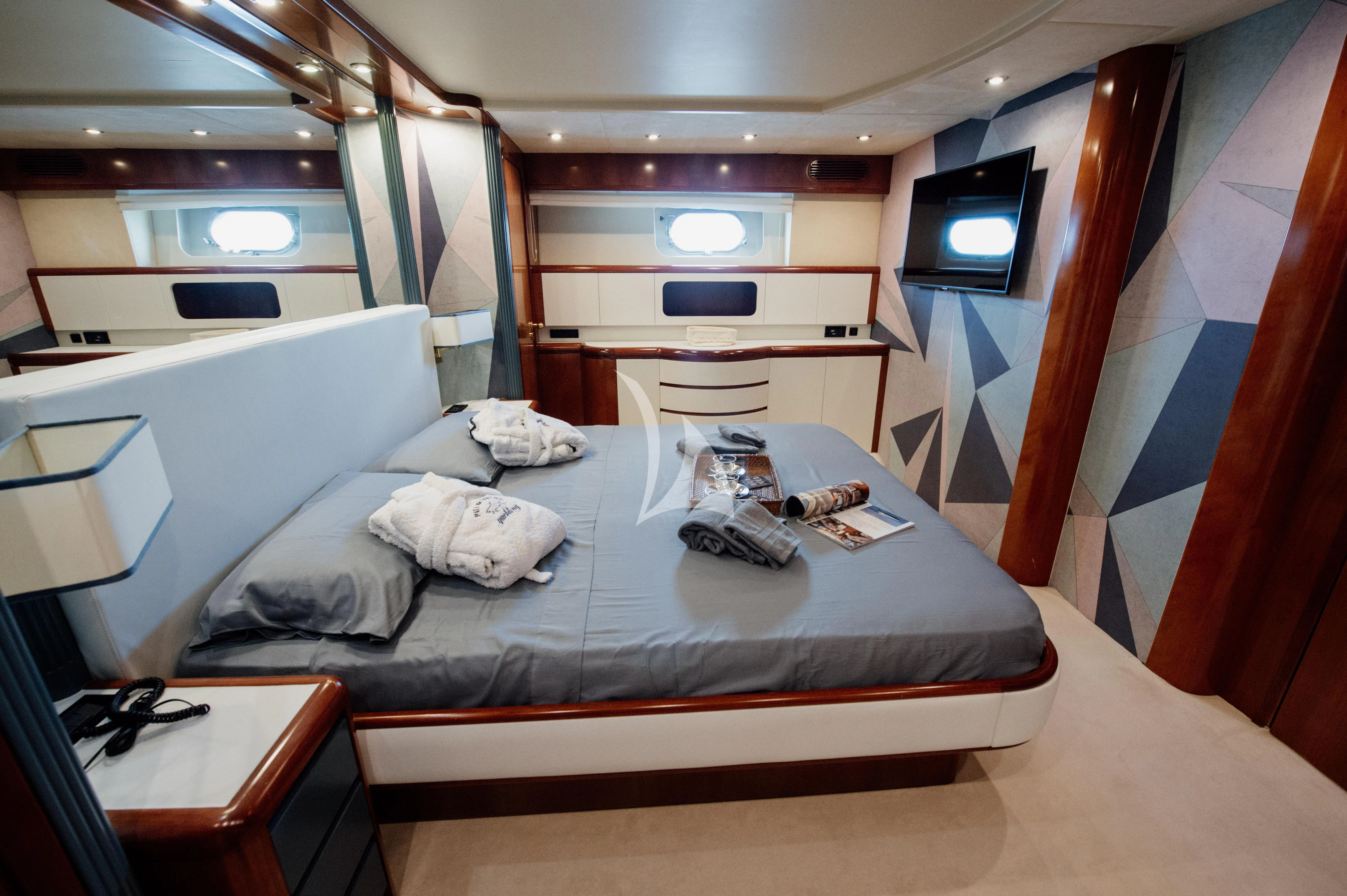 a bed with a white sheet and red curtains aboard BEYOND Yacht for Charter