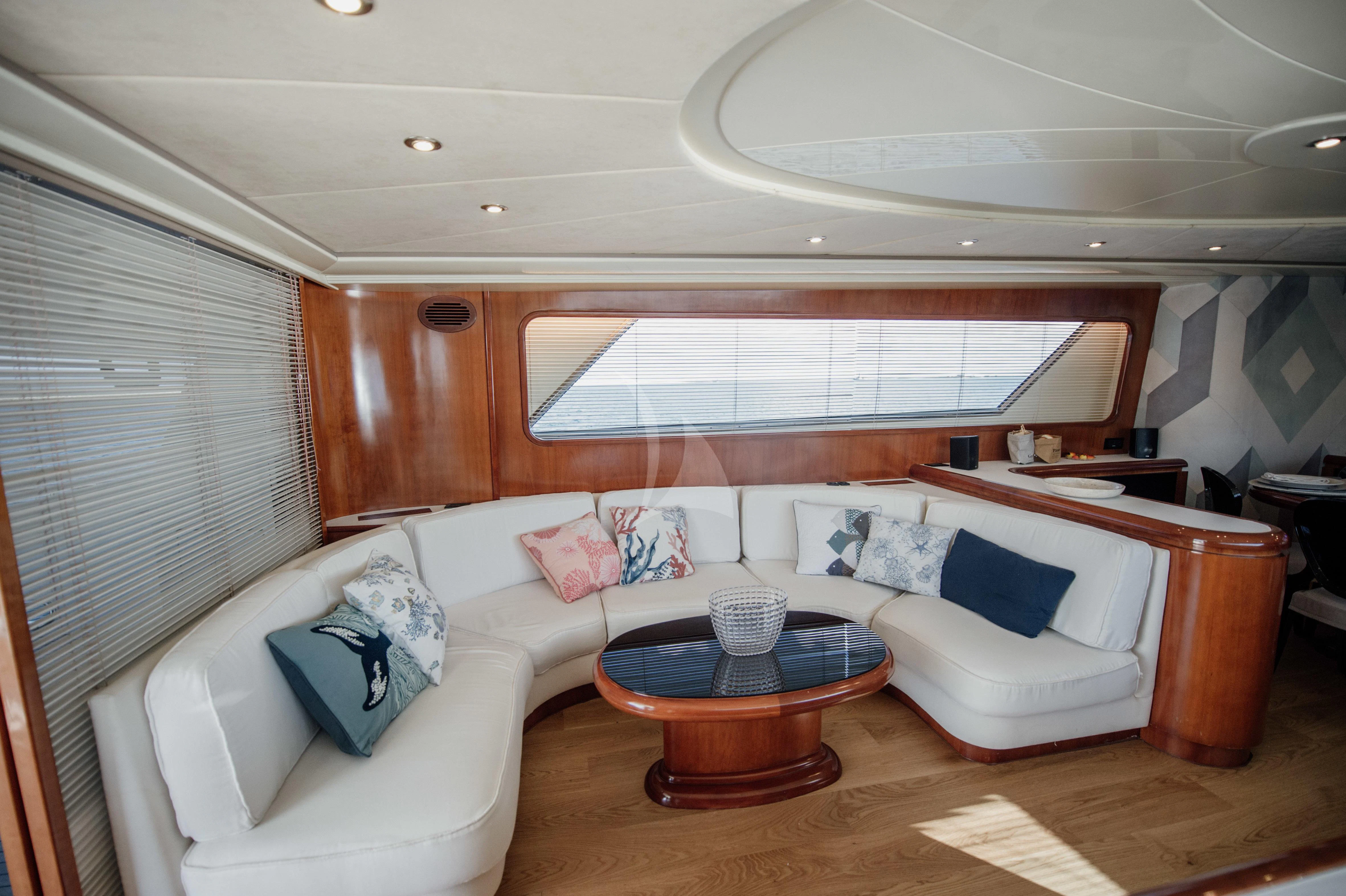 a living room with a couch and a table aboard BEYOND Yacht for Charter
