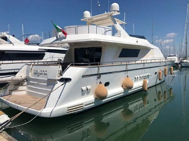 a white boat in a harbor aboard BEYOND Yacht for Charter