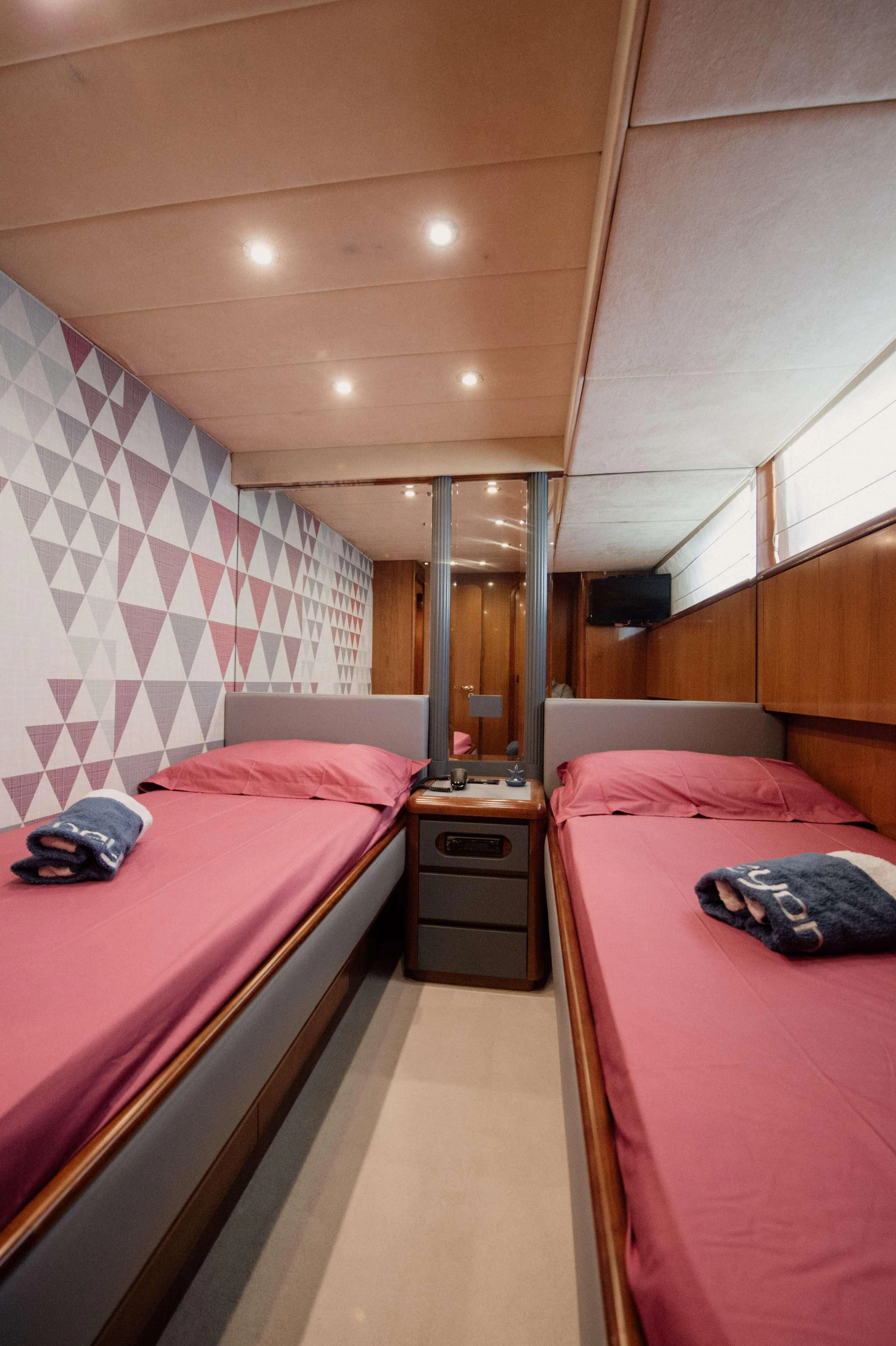 a room with two beds aboard BEYOND Yacht for Charter
