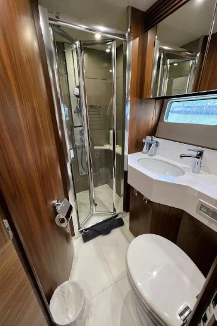 a bathroom with a glass shower door aboard RAPALLO V Yacht for Sale