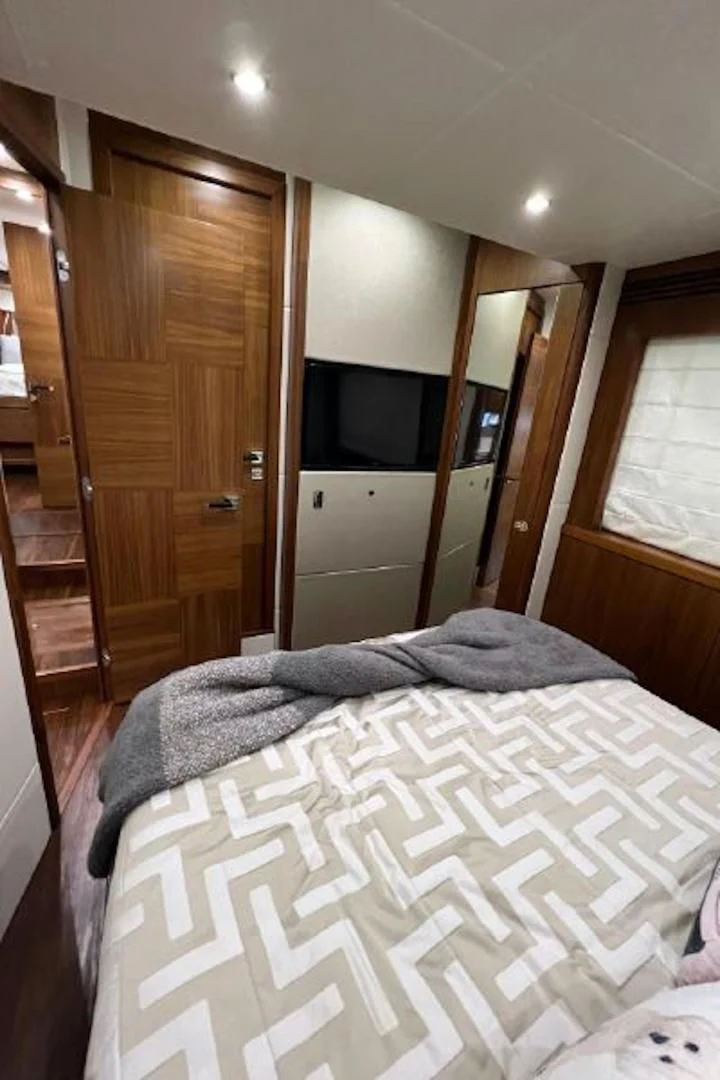 a bedroom with a bed and a television aboard RAPALLO V Yacht for Sale