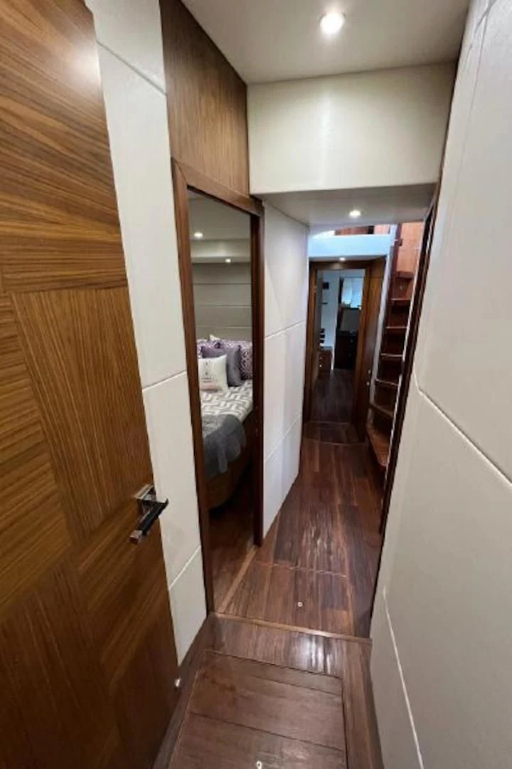 a hallway with a bed and a mirror aboard RAPALLO V Yacht for Sale