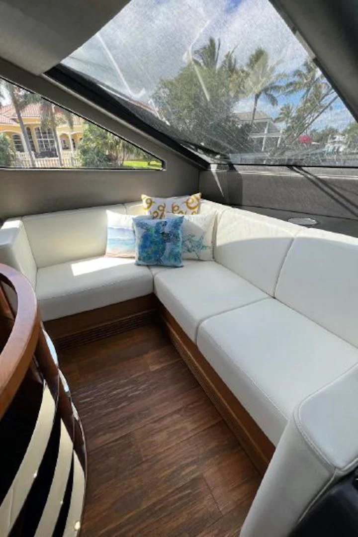 a room with a couch and a window aboard RAPALLO V Yacht for Sale