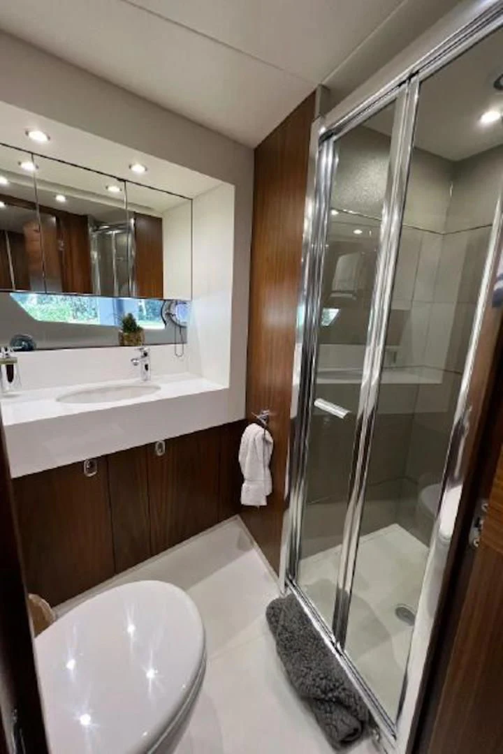 a bathroom with a large glass shower aboard RAPALLO V Yacht for Sale