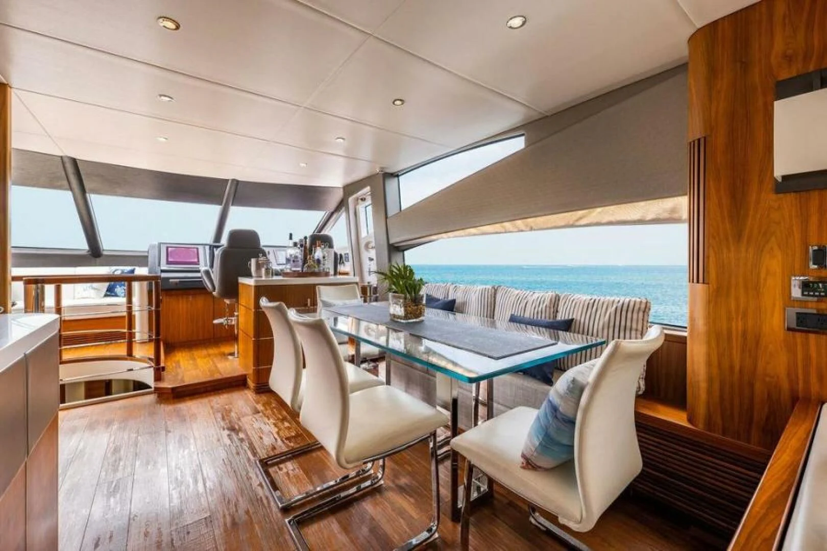 a room with a table chairs and a large window aboard RAPALLO V Yacht for Sale