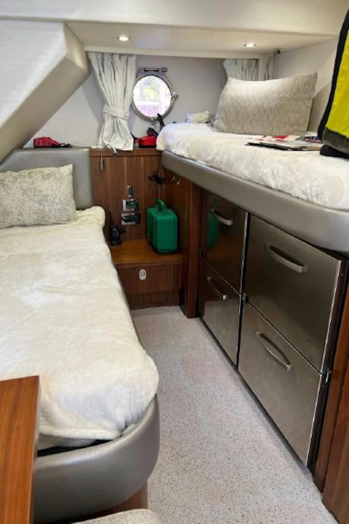 a small bedroom with a small bed aboard RAPALLO V Yacht for Sale