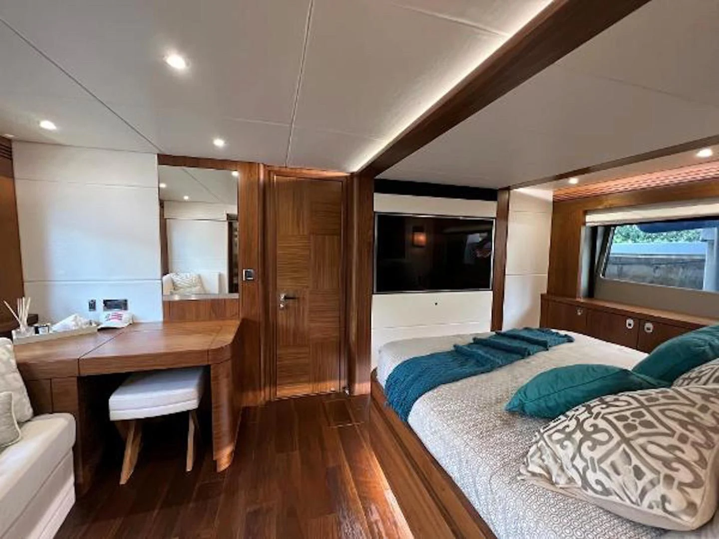 a bedroom with a bed and desk aboard RAPALLO V Yacht for Sale