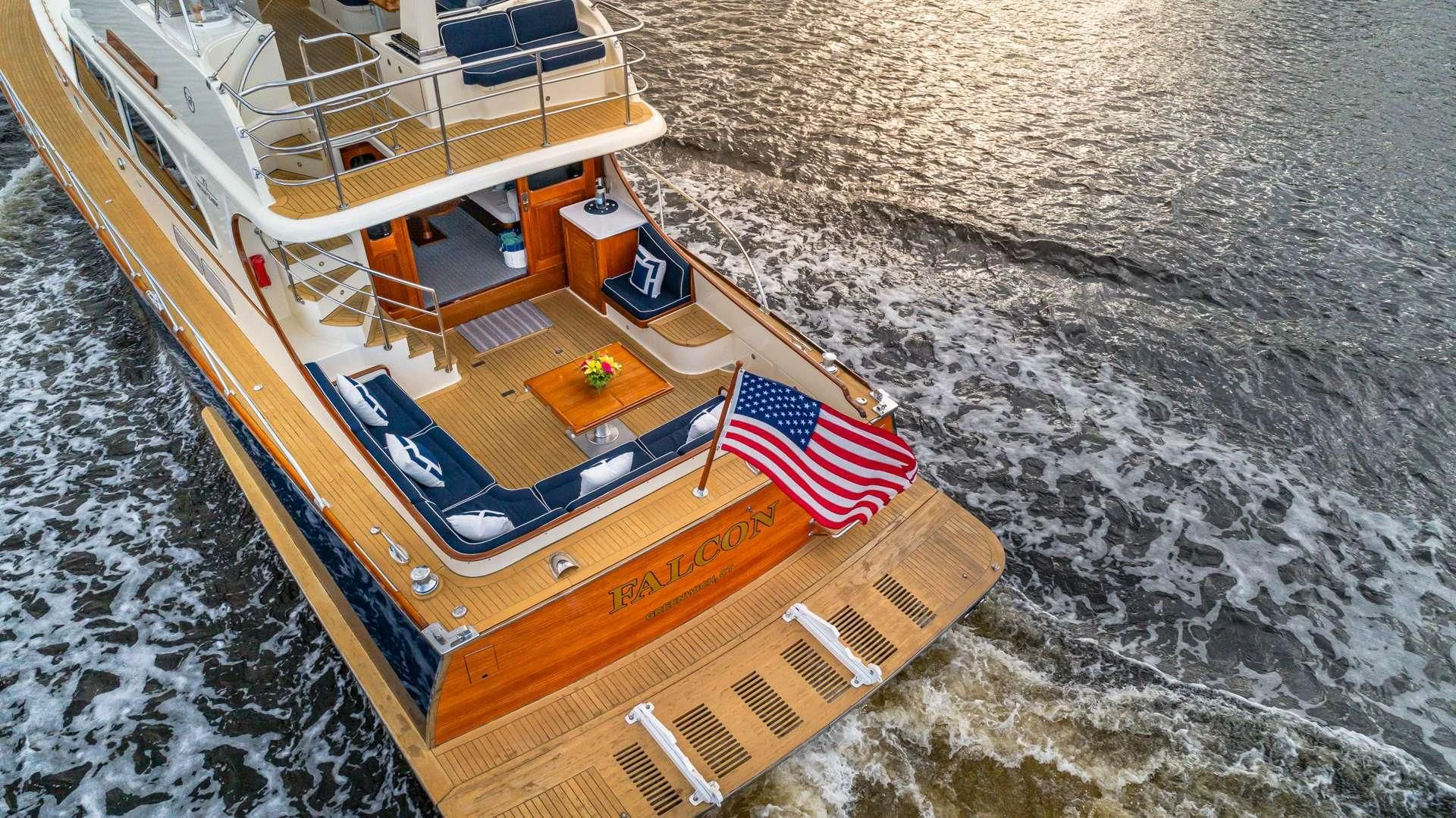 a boat with a flag on the front aboard FALCON Yacht for Sale