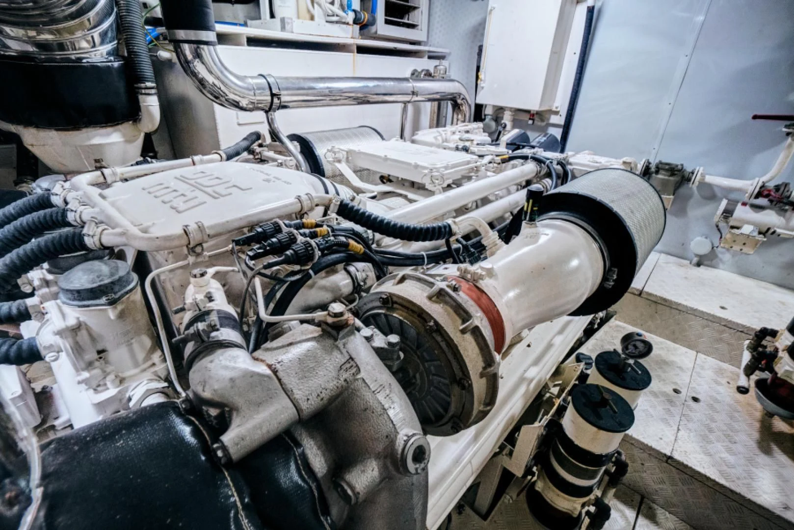 a car engine with a piece of paper on the hood aboard EL FARAON Yacht for Sale