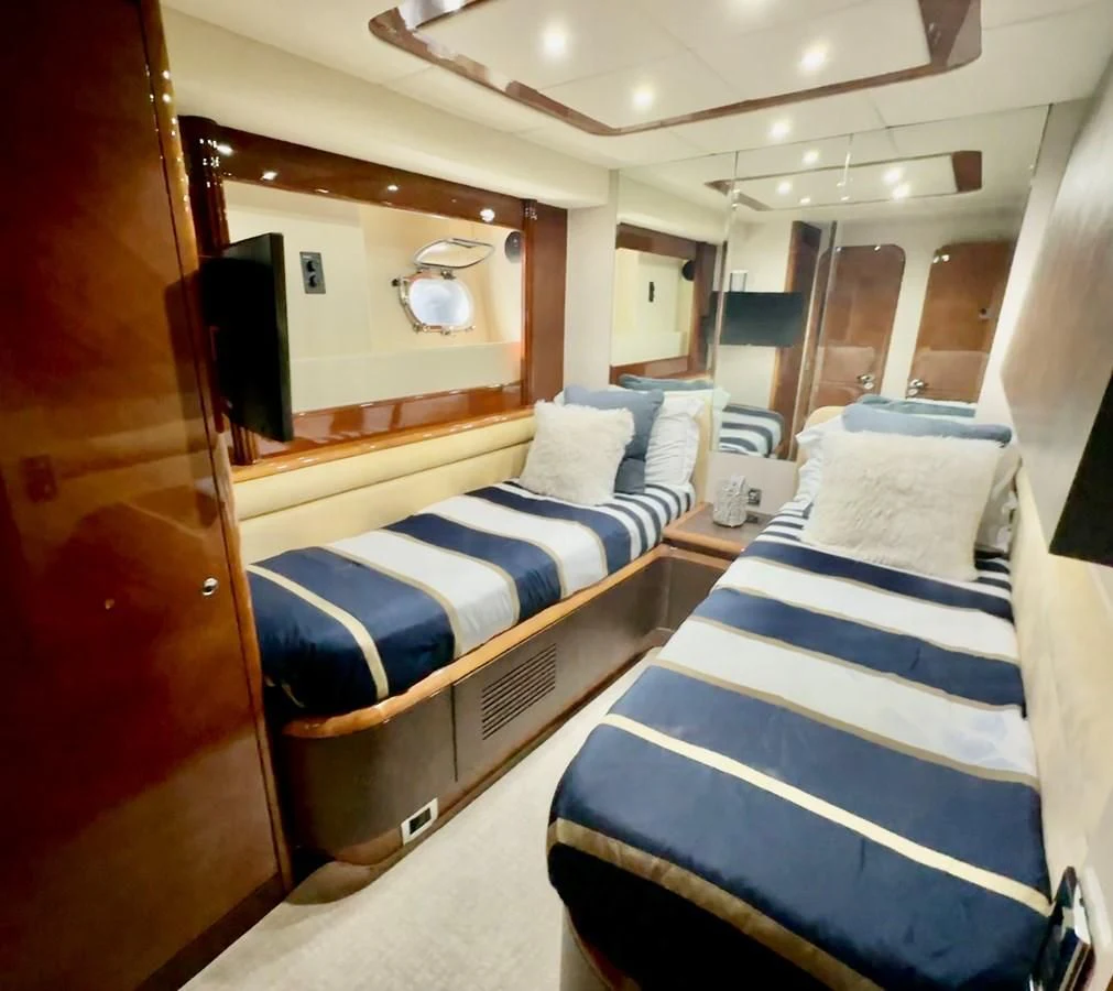 a room with beds and a mirror aboard EL FARAON Yacht for Sale