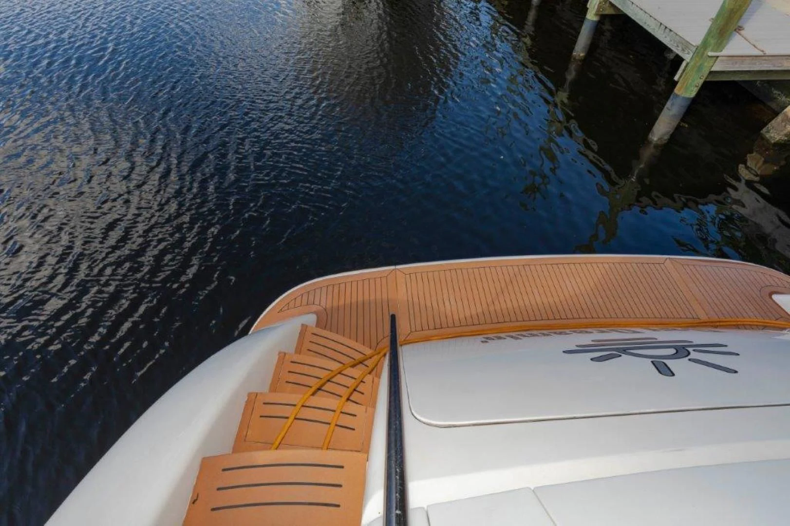 a white boat with a wooden dock aboard EL FARAON Yacht for Sale