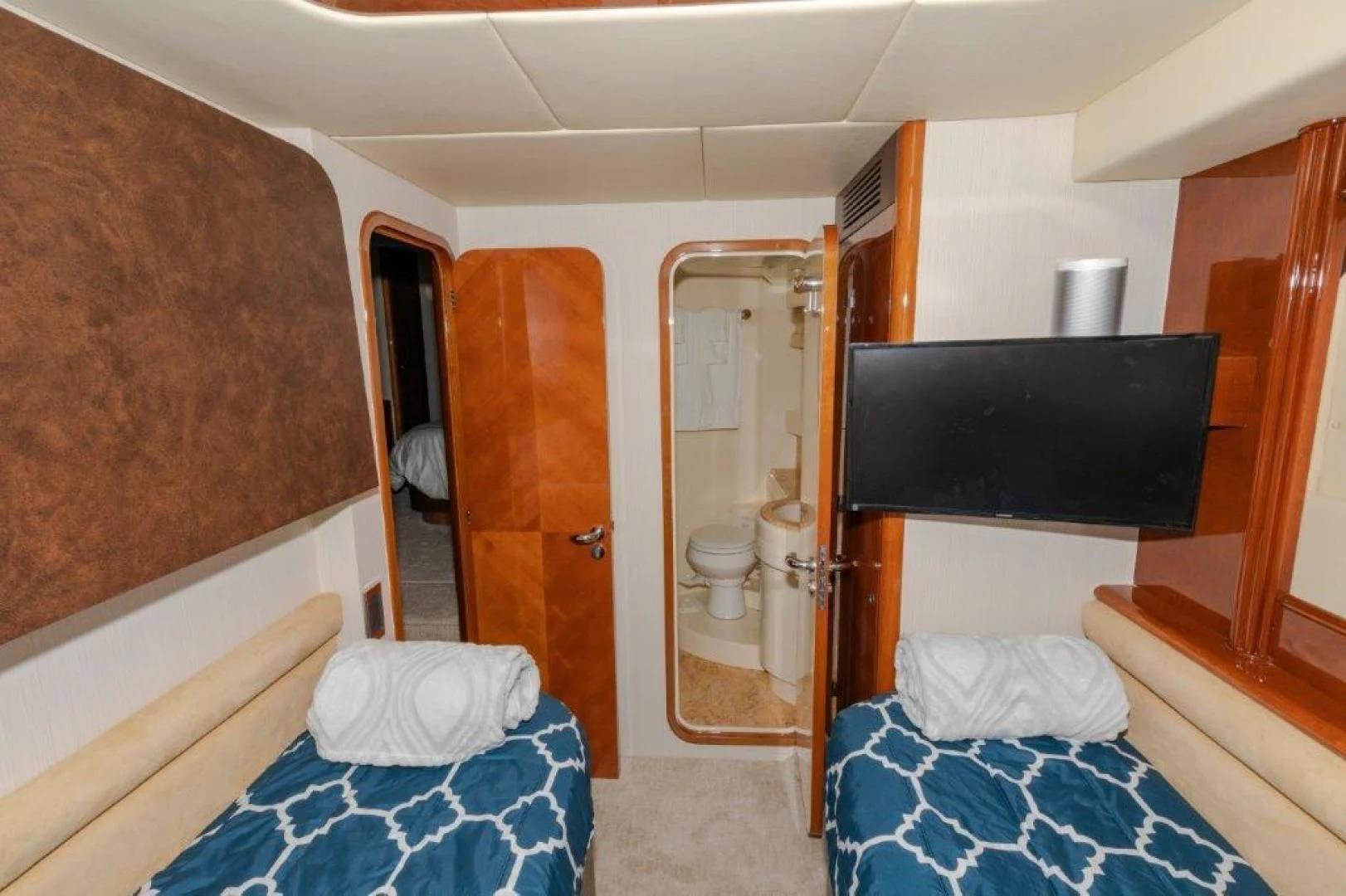 a bedroom with a bed and a television aboard EL FARAON Yacht for Sale