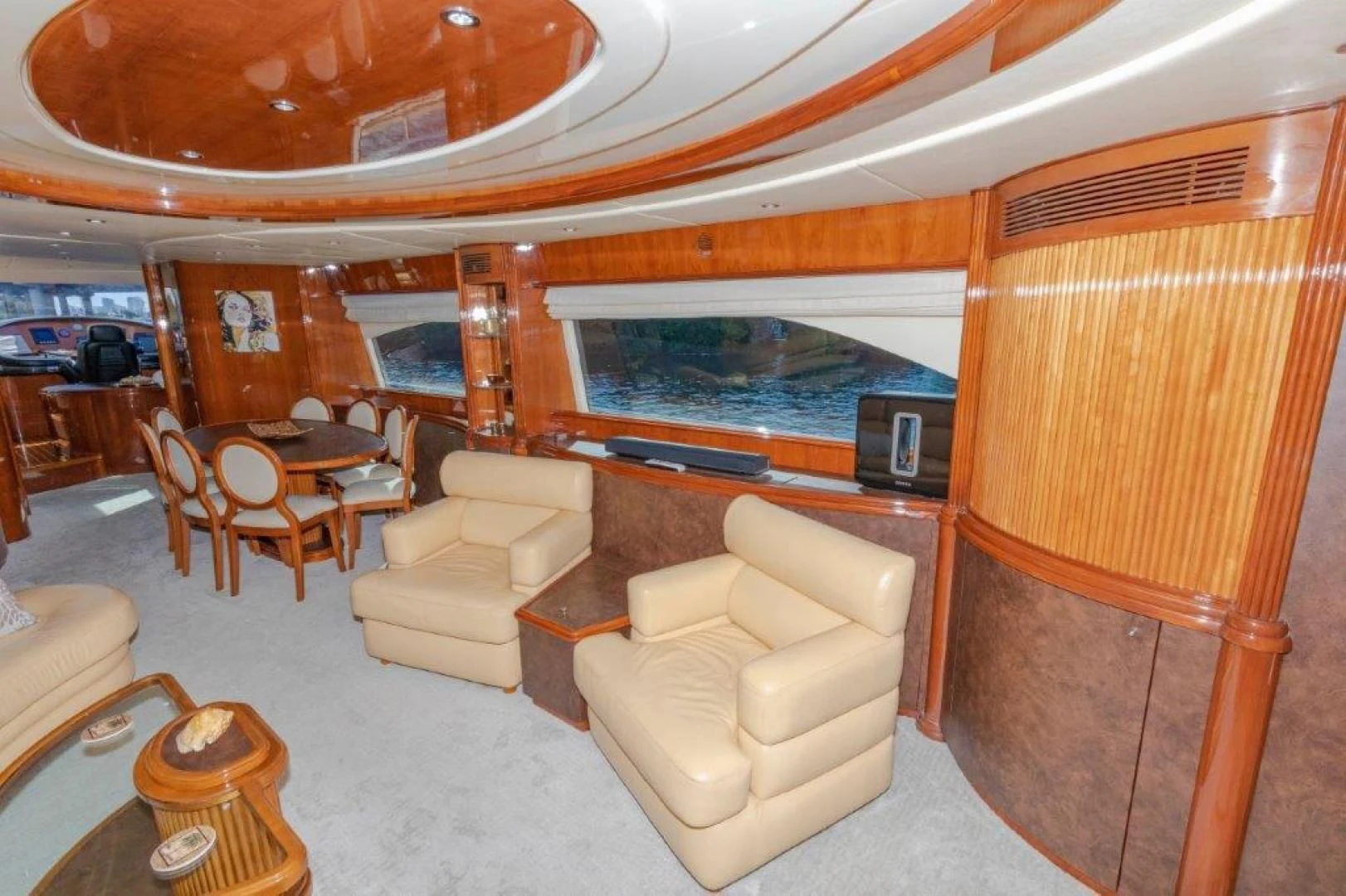 a room with a large window and a table and chairs aboard EL FARAON Yacht for Sale