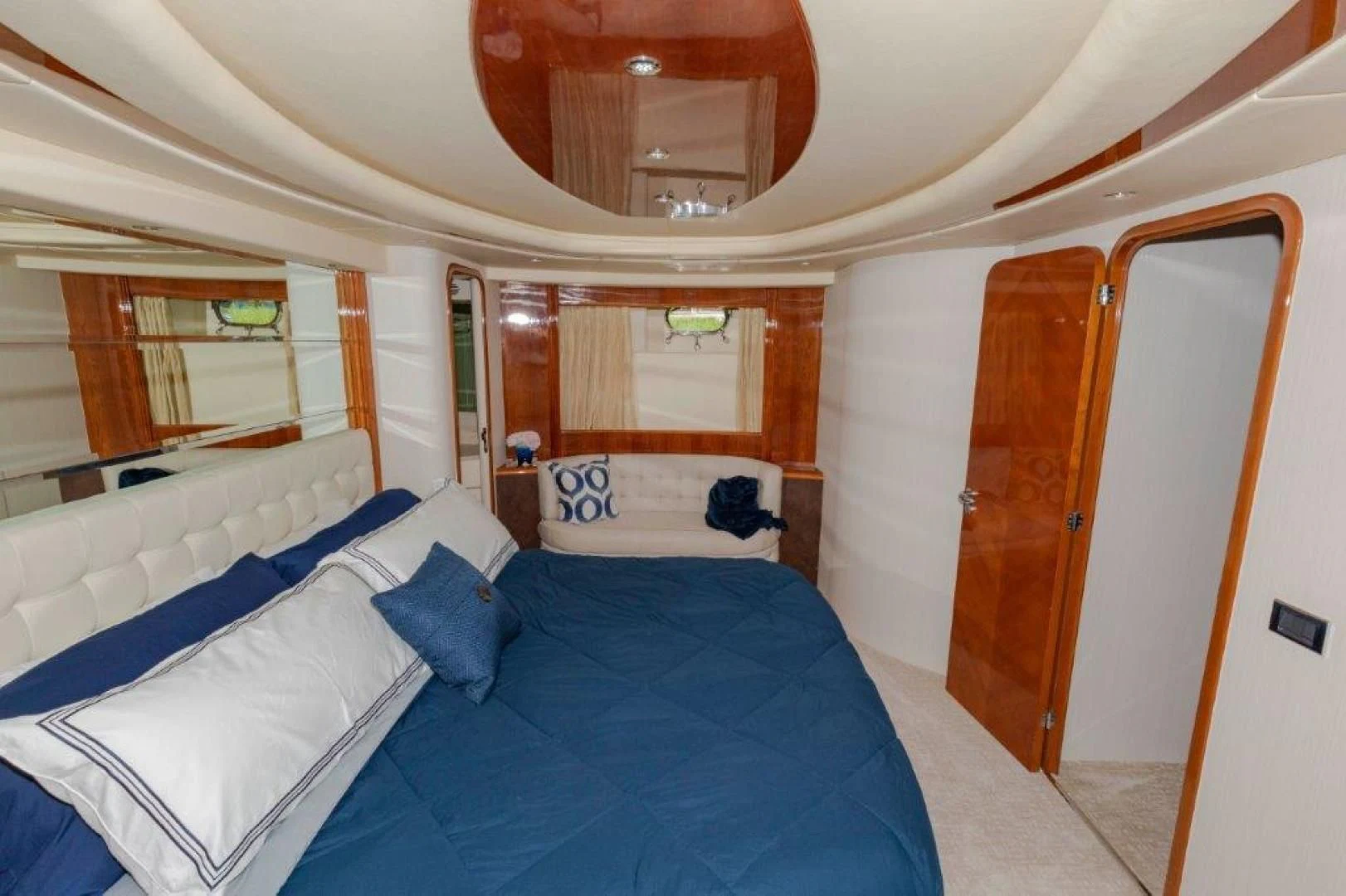 a room with a bed and a mirror aboard EL FARAON Yacht for Sale
