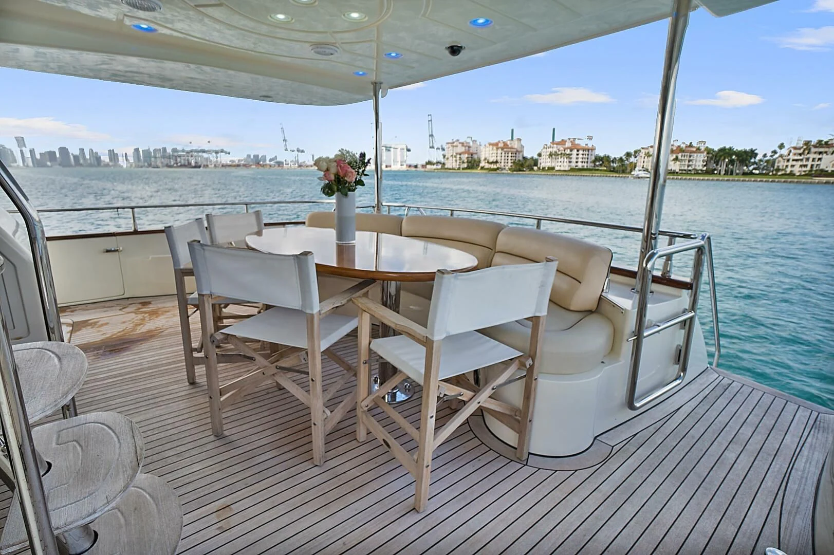 a table and chairs on a deck overlooking a body of water aboard EL FARAON Yacht for Sale