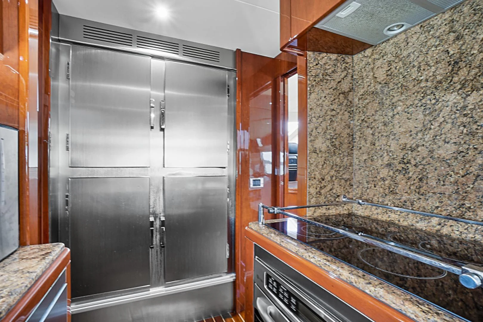 a kitchen with a steel door aboard EL FARAON Yacht for Sale