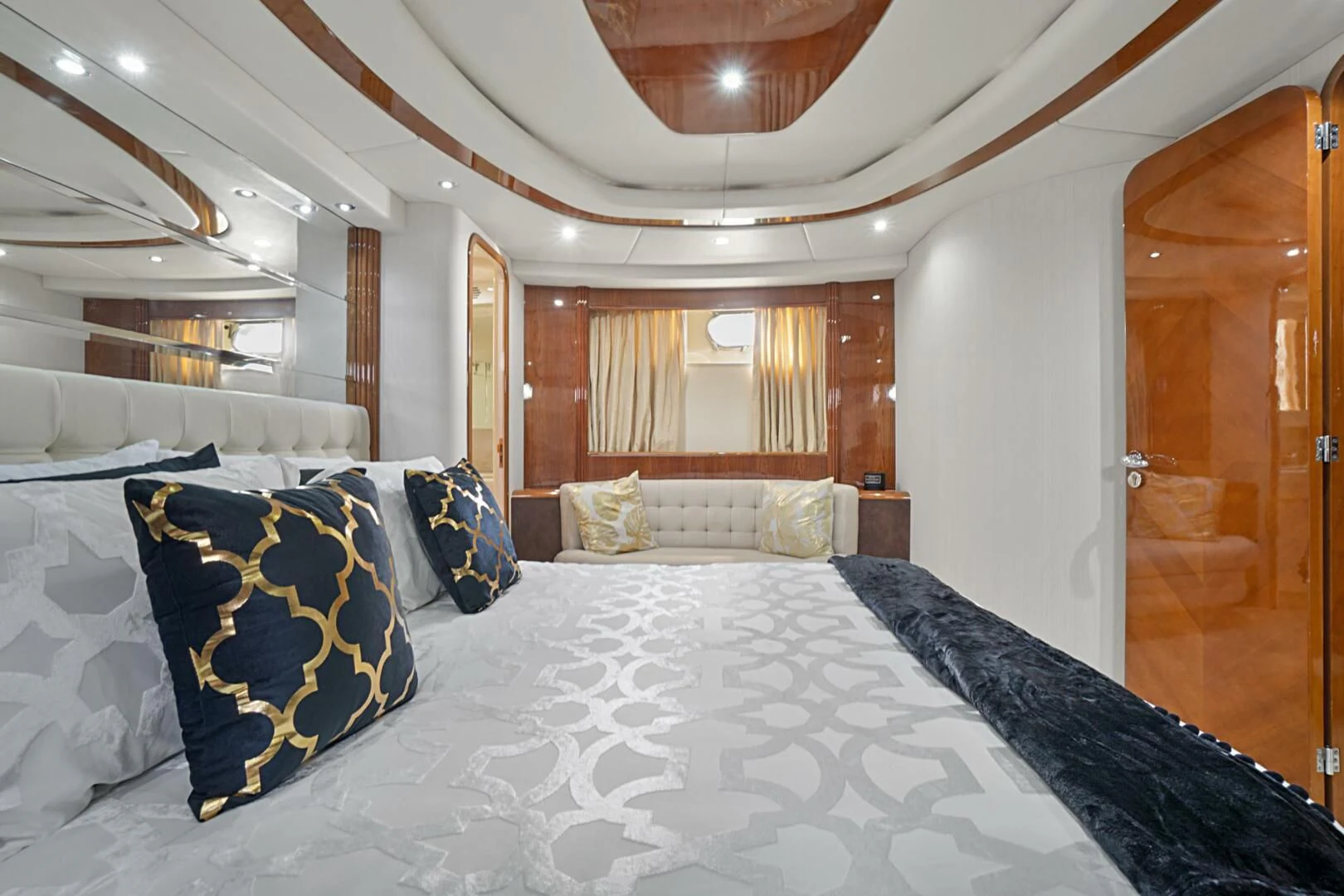 a large bed with blue and white sheets aboard EL FARAON Yacht for Sale