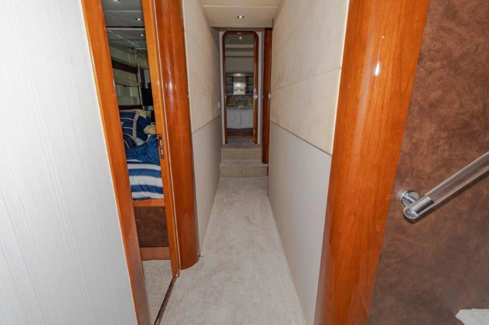 a hallway with a door and a rug on the floor aboard EL FARAON Yacht for Sale