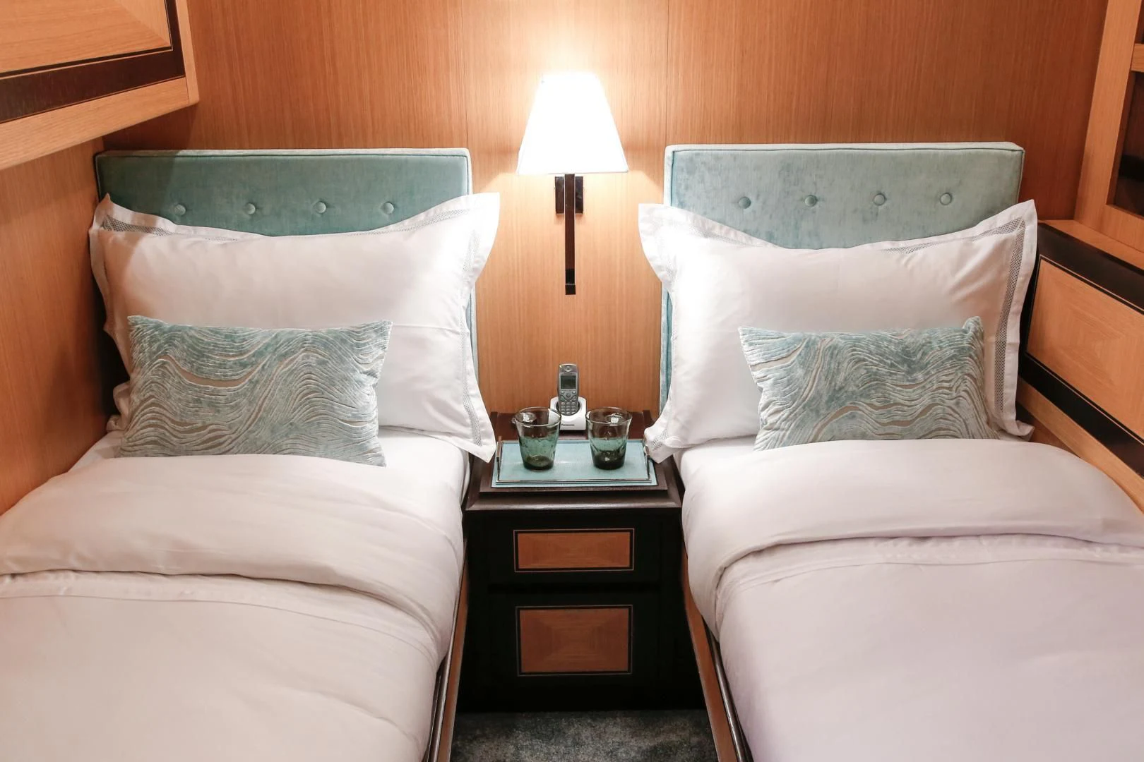 a bed with pillows and a lamp aboard THE OFFICE Yacht for Sale