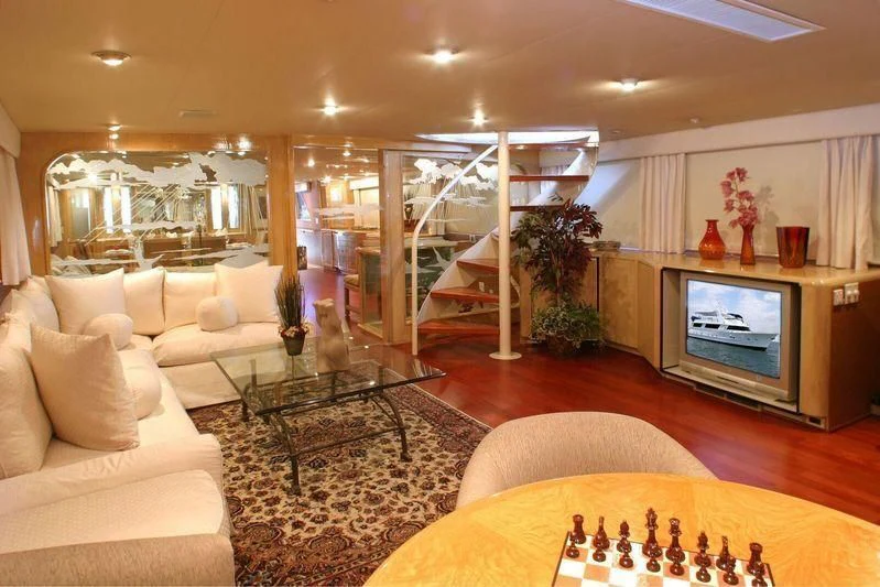 a living room with a fireplace aboard THE ADMIRAL Yacht for Sale