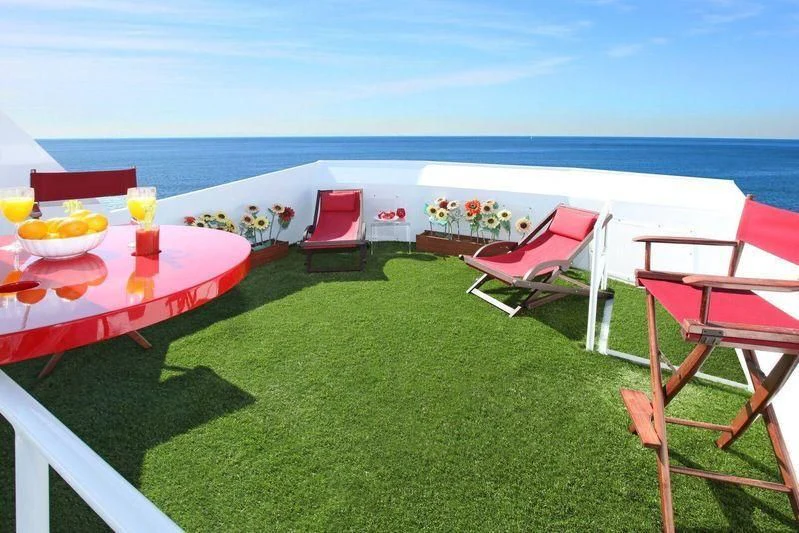a deck with chairs and tables on it by the water aboard THE ADMIRAL Yacht for Sale