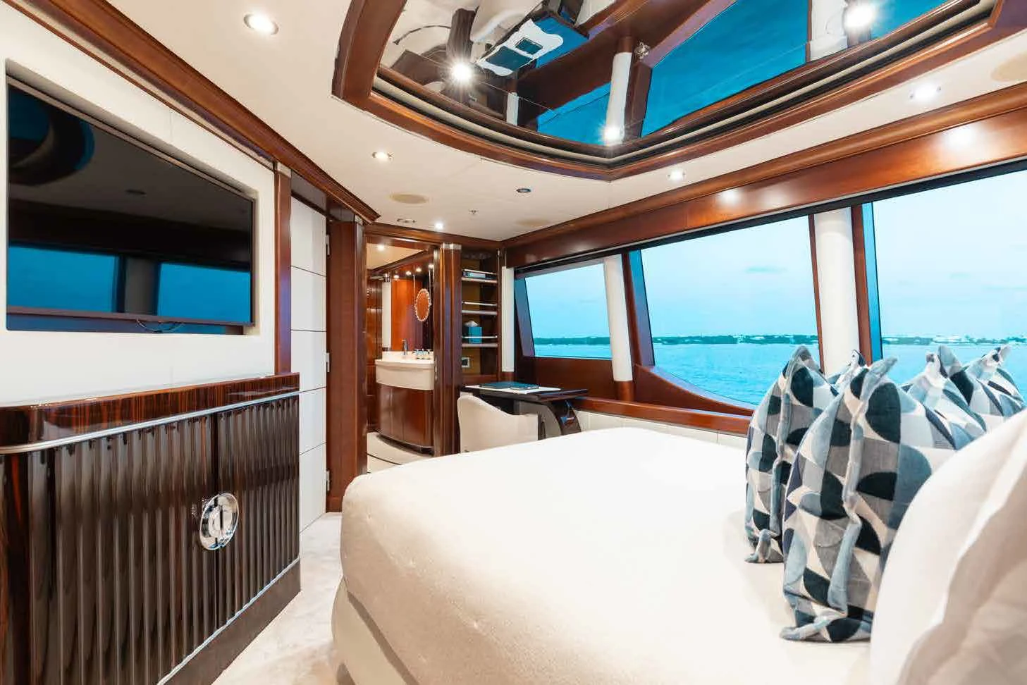 a room with a bed and a table aboard LADY B Yacht for Charter