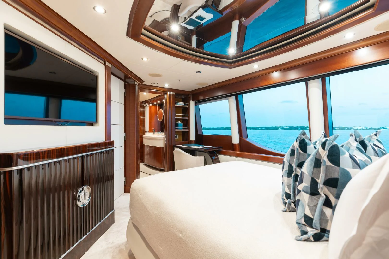 a room with a bed and a table aboard LADY B Yacht for Charter