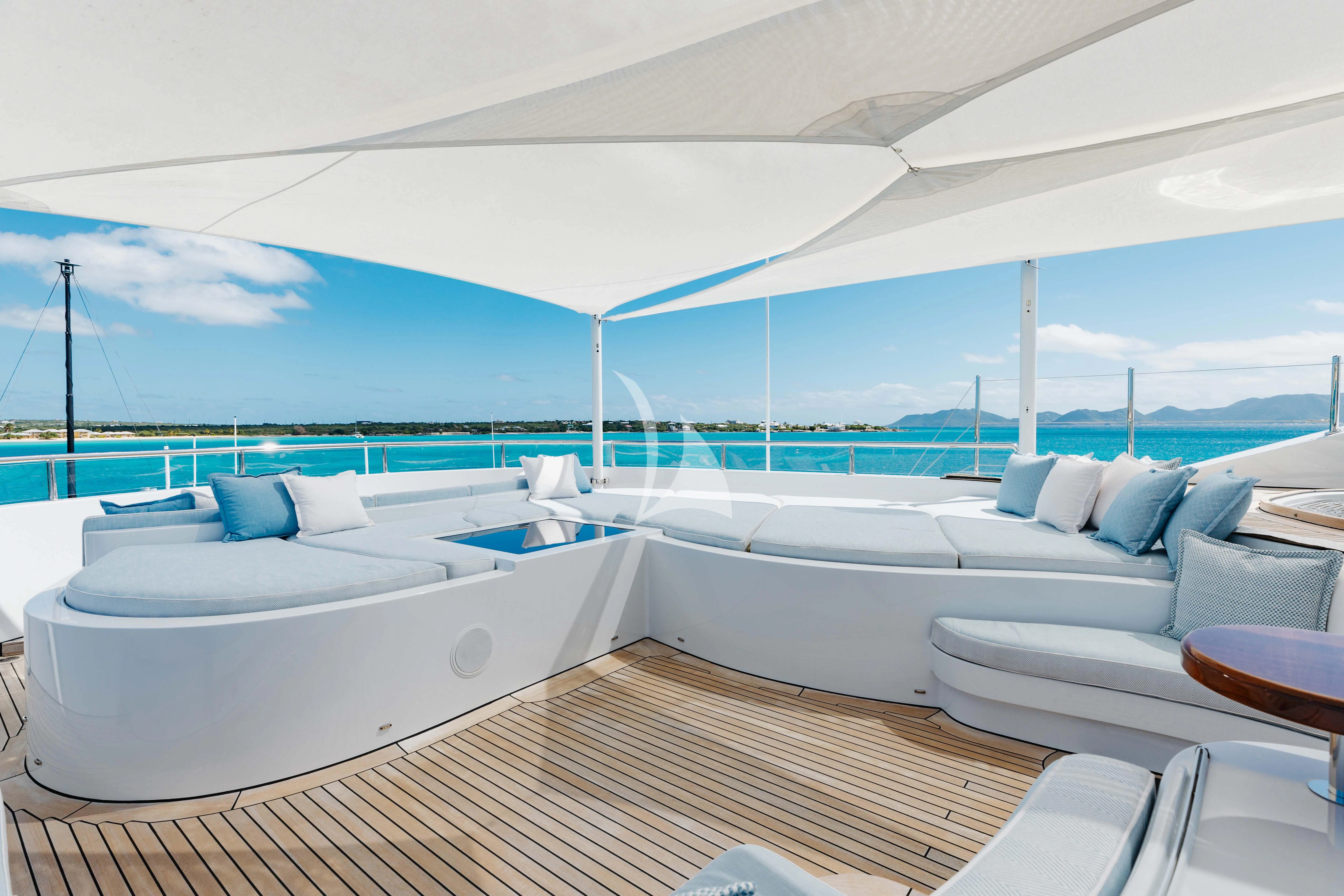 a room with a pool and lounge chairs aboard LADY B Yacht for Charter