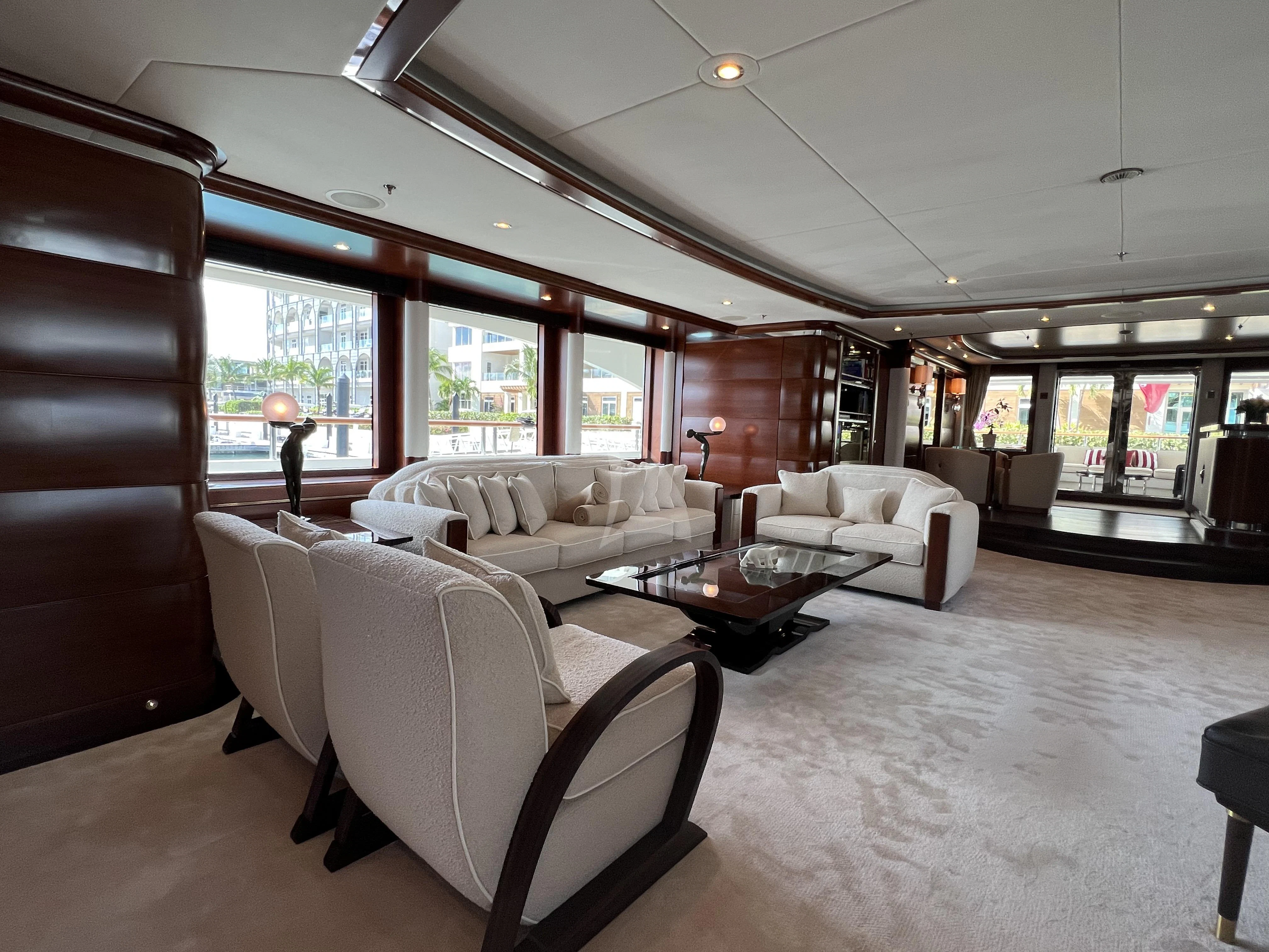 a living room with a large wood cabinet and white furniture aboard LADY B Yacht for Charter