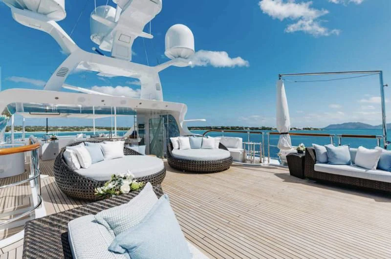 a room with a view of the ocean and a cruise ship aboard LADY B Yacht for Charter