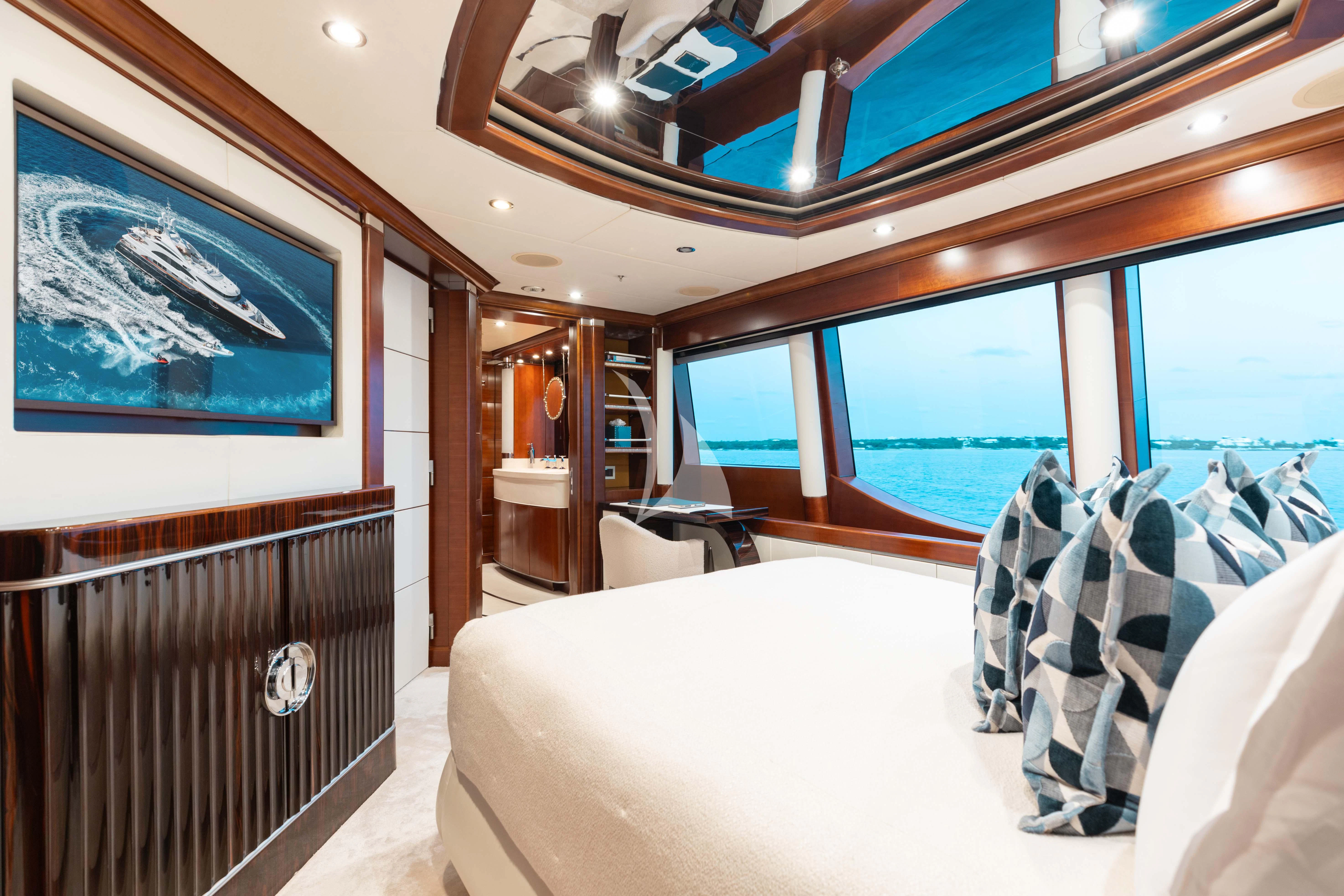 a room with a bed and a table aboard LADY B Yacht for Charter