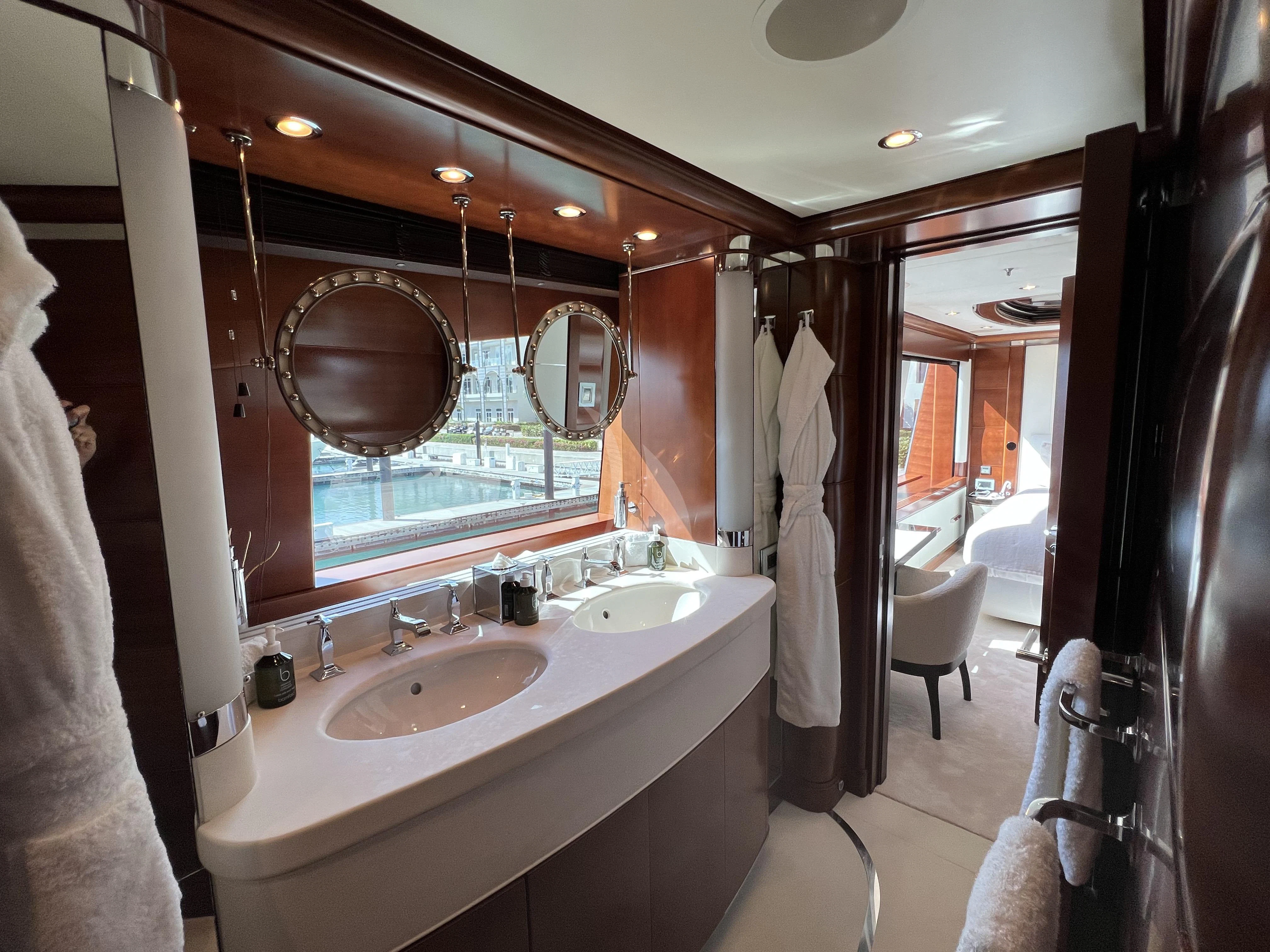 a bathroom with two sinks and mirrors aboard LADY B Yacht for Charter