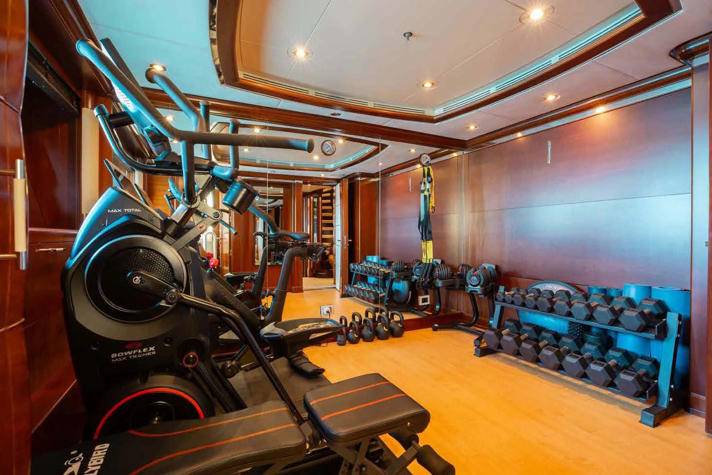 a large gym with equipment aboard LADY B Yacht for Charter