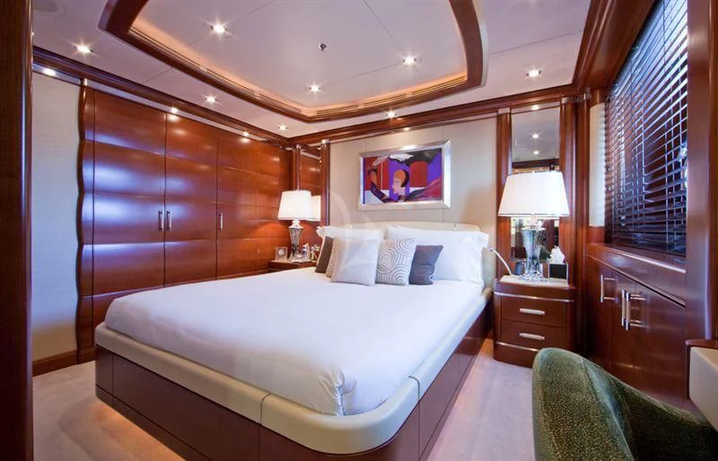 a bedroom with a bed and a desk aboard LADY B Yacht for Charter