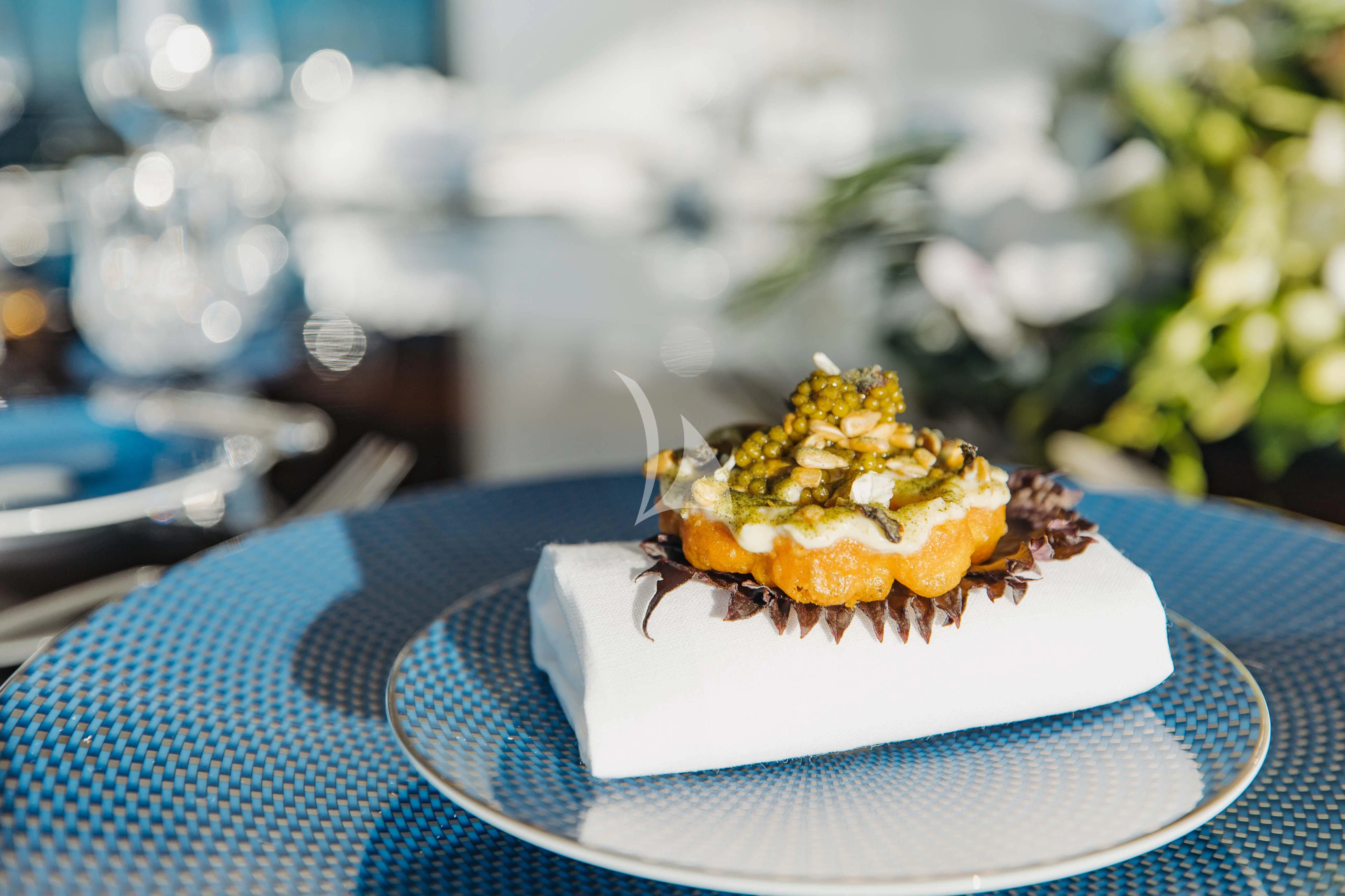 a small cake on a plate aboard LADY B Yacht for Charter
