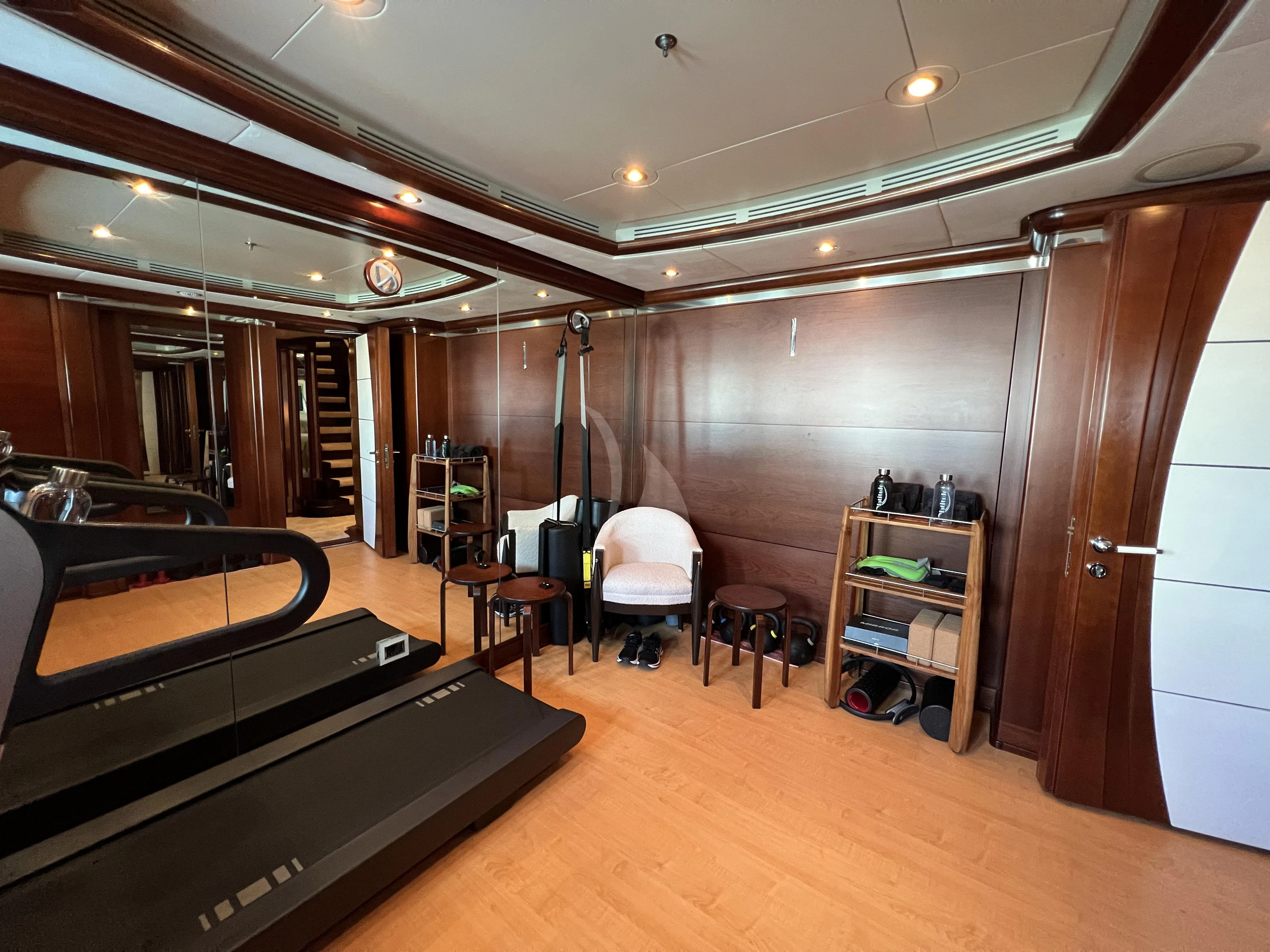 a room with a piano and a wood floor aboard LADY B Yacht for Charter