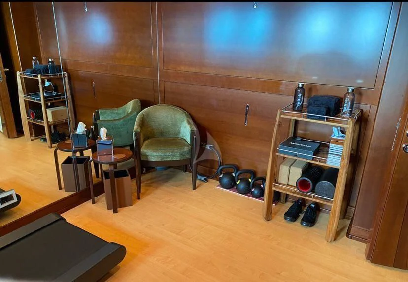 a room with a shelf and chairs aboard LADY B Yacht for Charter