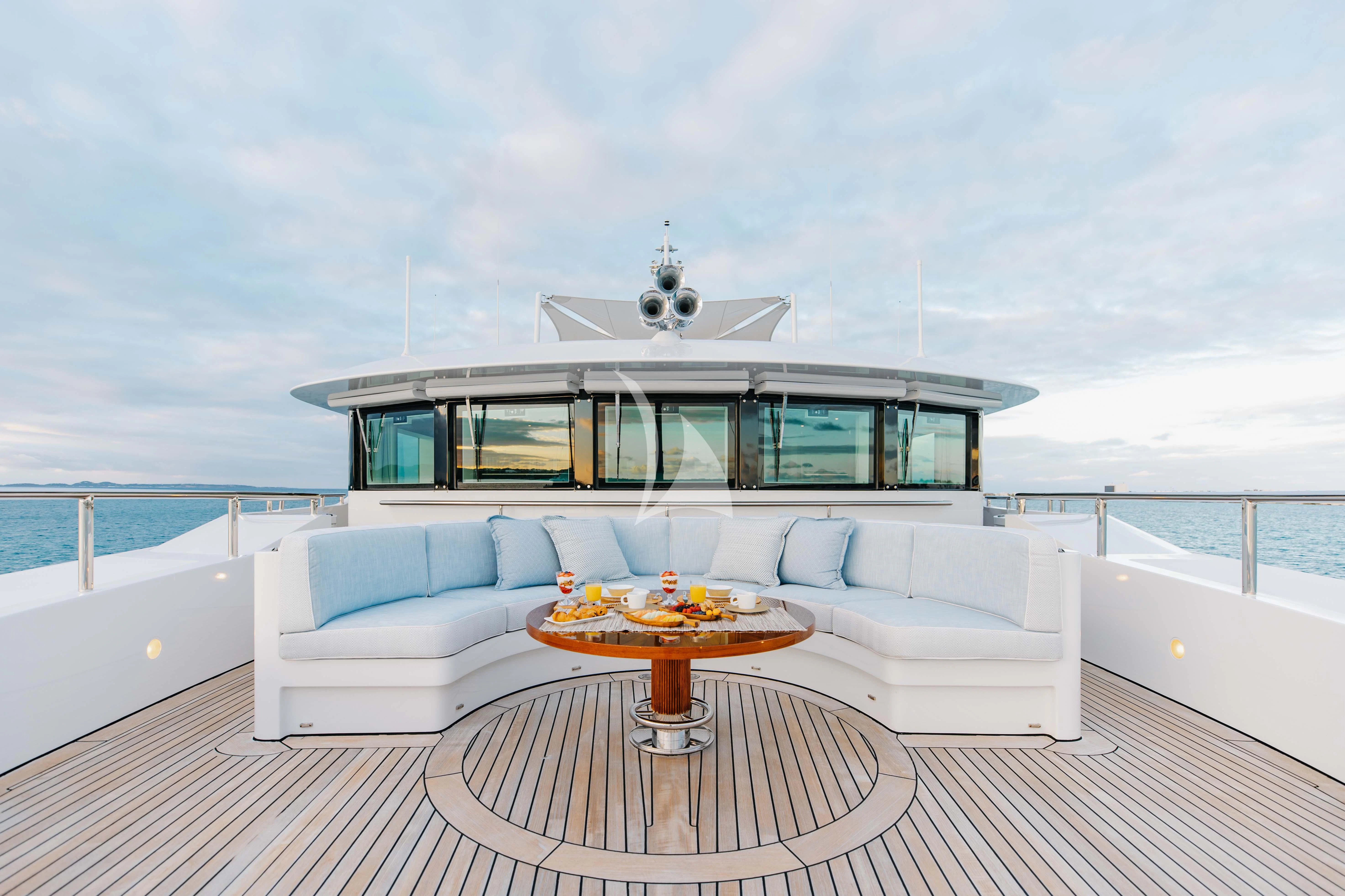 a living room with a large balcony aboard LADY B Yacht for Charter