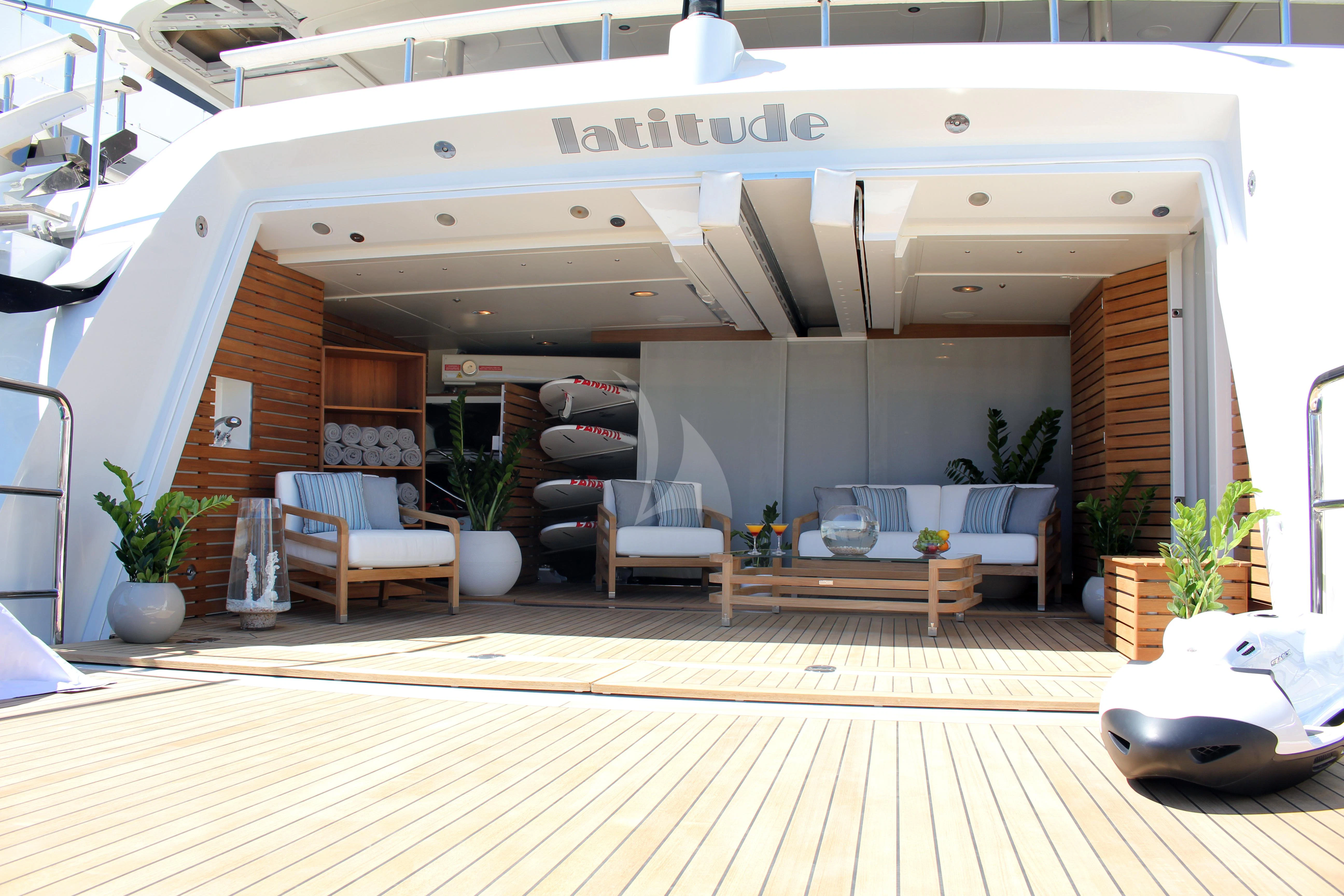 a large white building with a table and chairs aboard LADY B Yacht for Charter