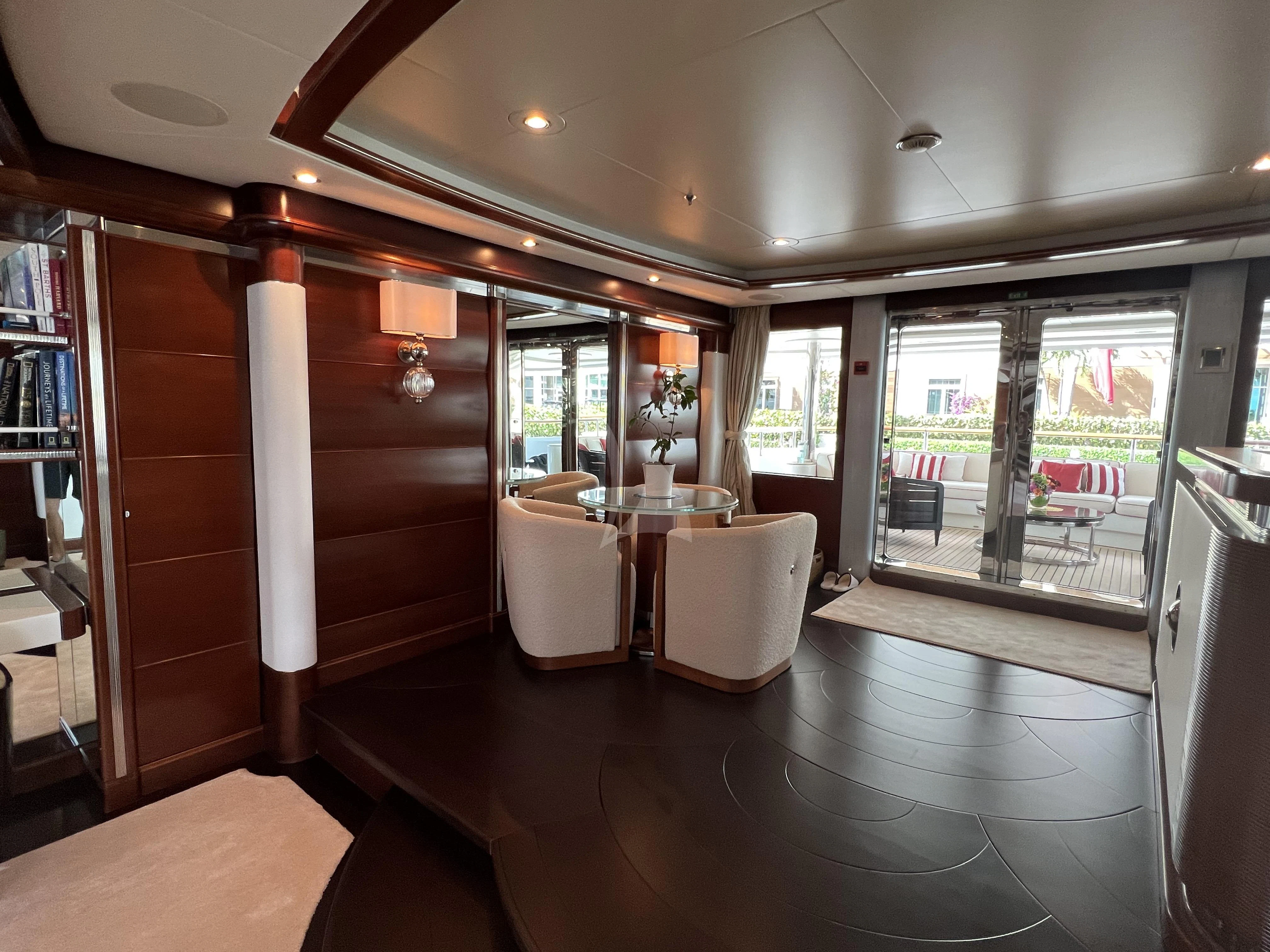 a room with a table and chairs aboard LADY B Yacht for Charter