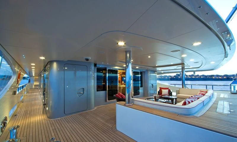 a train with a bed and a table and chairs aboard LADY B Yacht for Charter