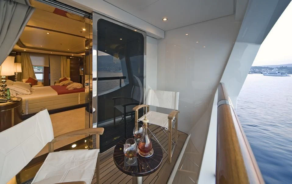 a room with a bed and a table aboard LADY B Yacht for Charter