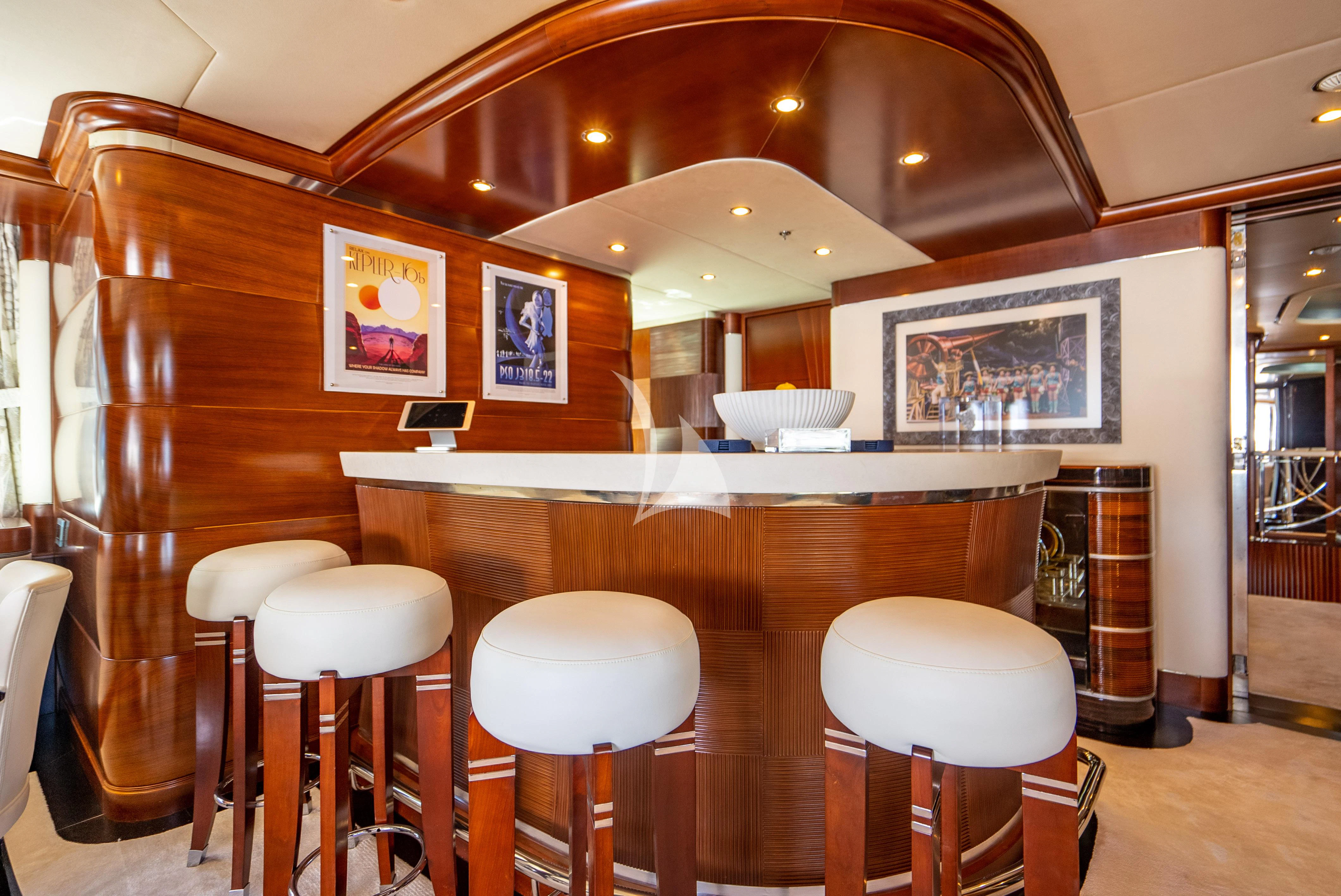 a bar with stools and tables aboard LADY B Yacht for Charter